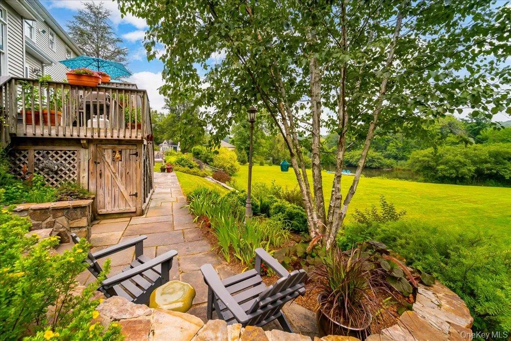 A lovely little patio nook to enjoy on a nice day or cool evening overlooks your expansive yard with pond and private island! A lovely little patio nook to enjoy on a nice day or cool evening overlooks your expansive yard with pond and private island!