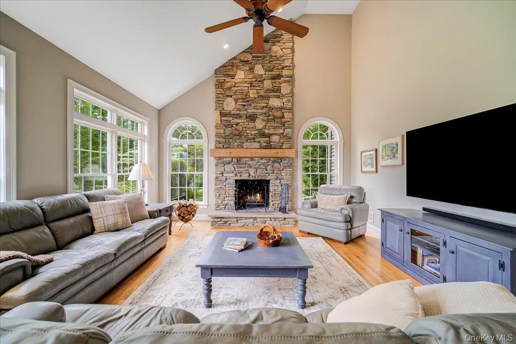 Open flow to the kitchen, this room is one of the highlights of this home and overlooks the stunning yard and pond. Open flow to the kitchen, this room is one of the highlights of this home and overlooks the stunning yard and pond.