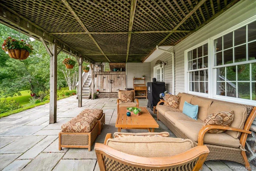 Covered large patio area below the deck for additional shaded seating and lovely views of the yard/pond. Covered large patio area below the deck for additional shaded seating and lovely views of the yard/pond.