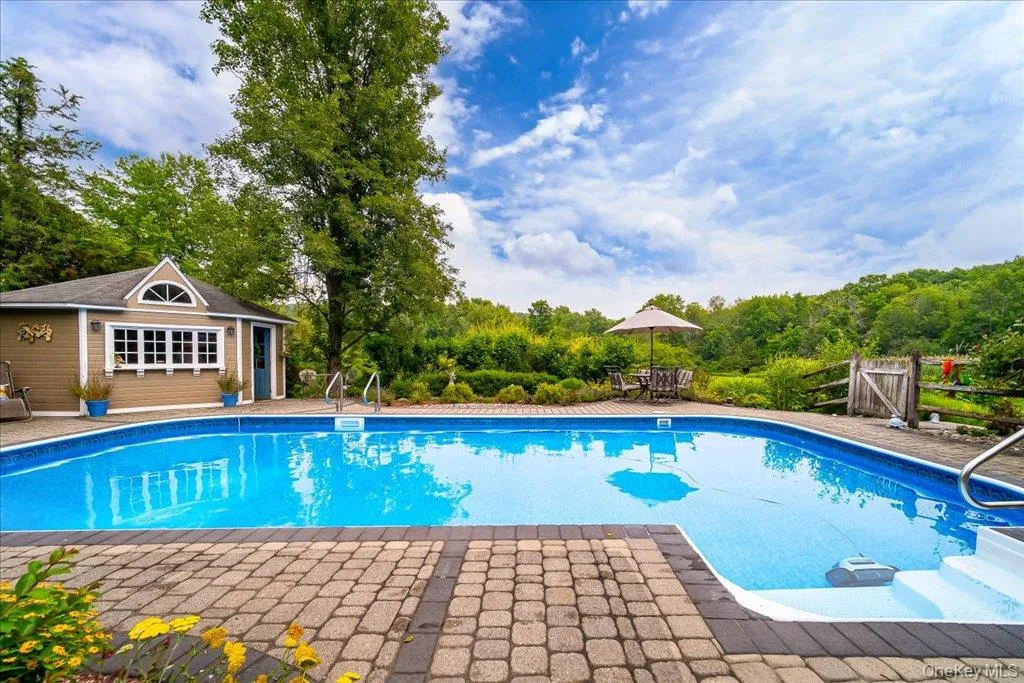Fantastic and private in-ground pool surrounded with lovely landscaping, a paver patio, multiple seating dining areas and a cabana/pool house. Fantastic and private in-ground pool surrounded with lovely landscaping, a paver patio, multiple seating dining areas and a cabana/pool house.