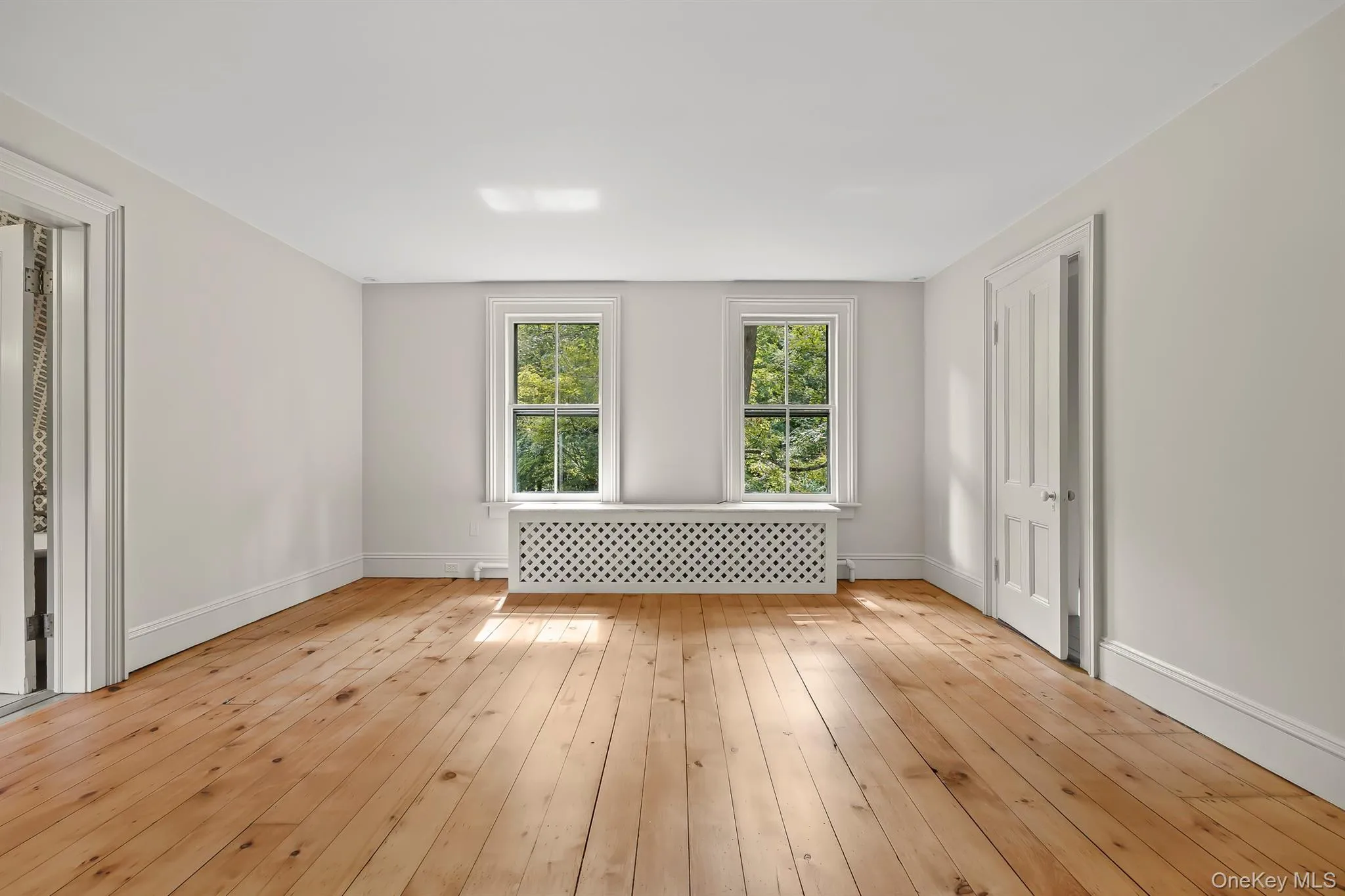 Primary Bedroom with Walk-in Closet and Gleaming Hardwood Floors Primary Bedroom with Walk-in Closet and Gleaming Hardwood Floors