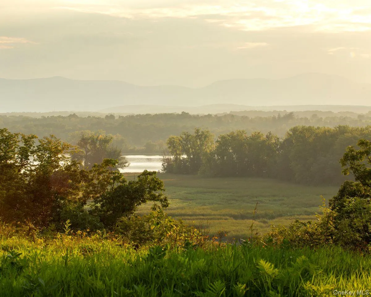 Property view of mountains with a water view and a view of trees Property view of mountains with a water view and a view of trees