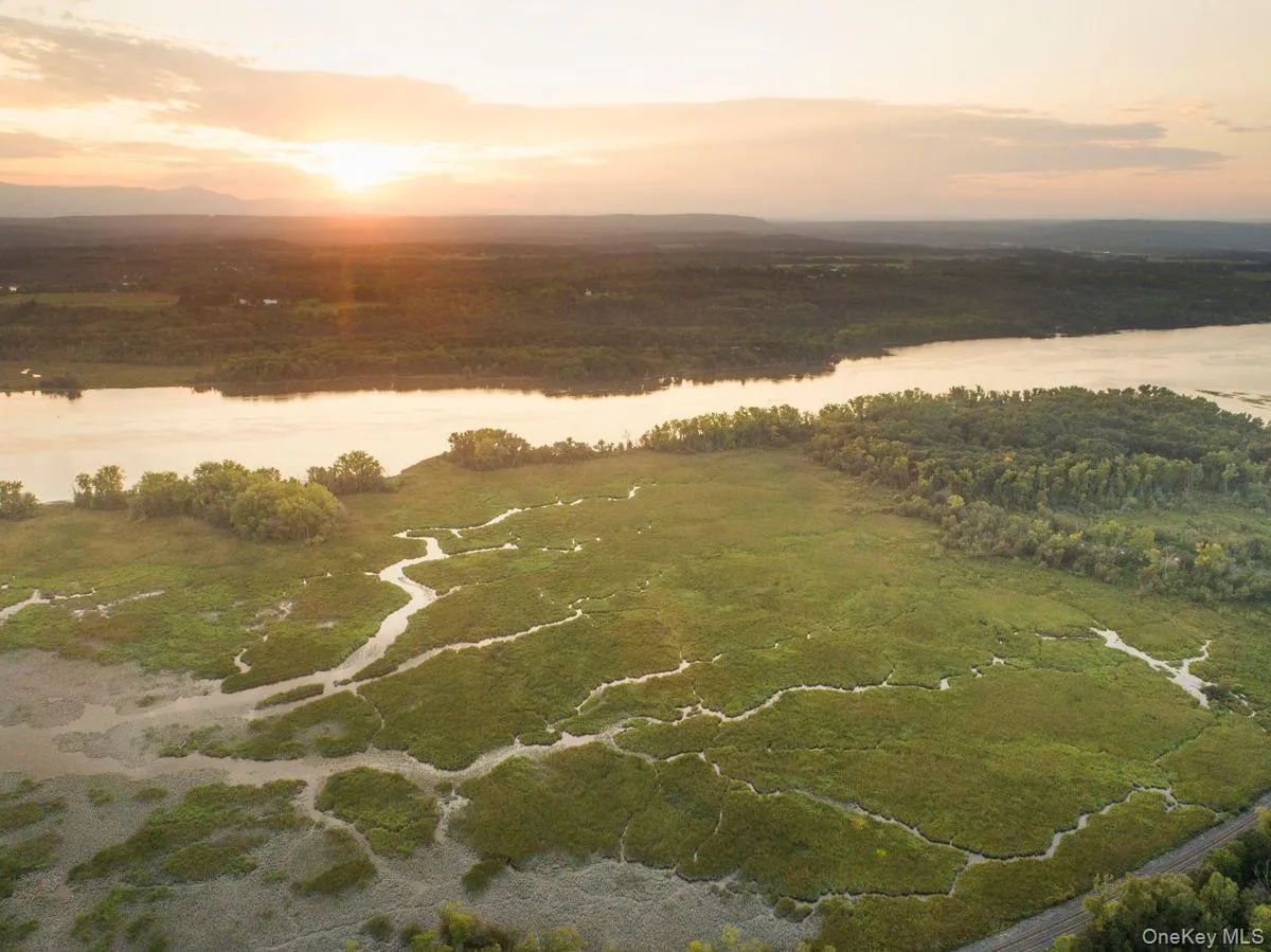Aerial view at dusk featuring a water view Aerial view at dusk featuring a water view