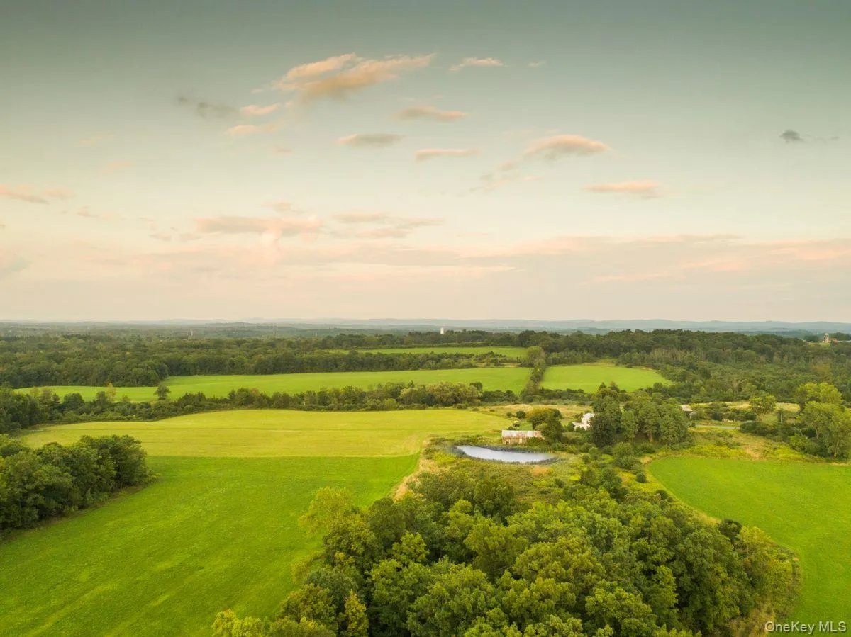 Aerial view at dusk featuring a water view Aerial view at dusk featuring a water view