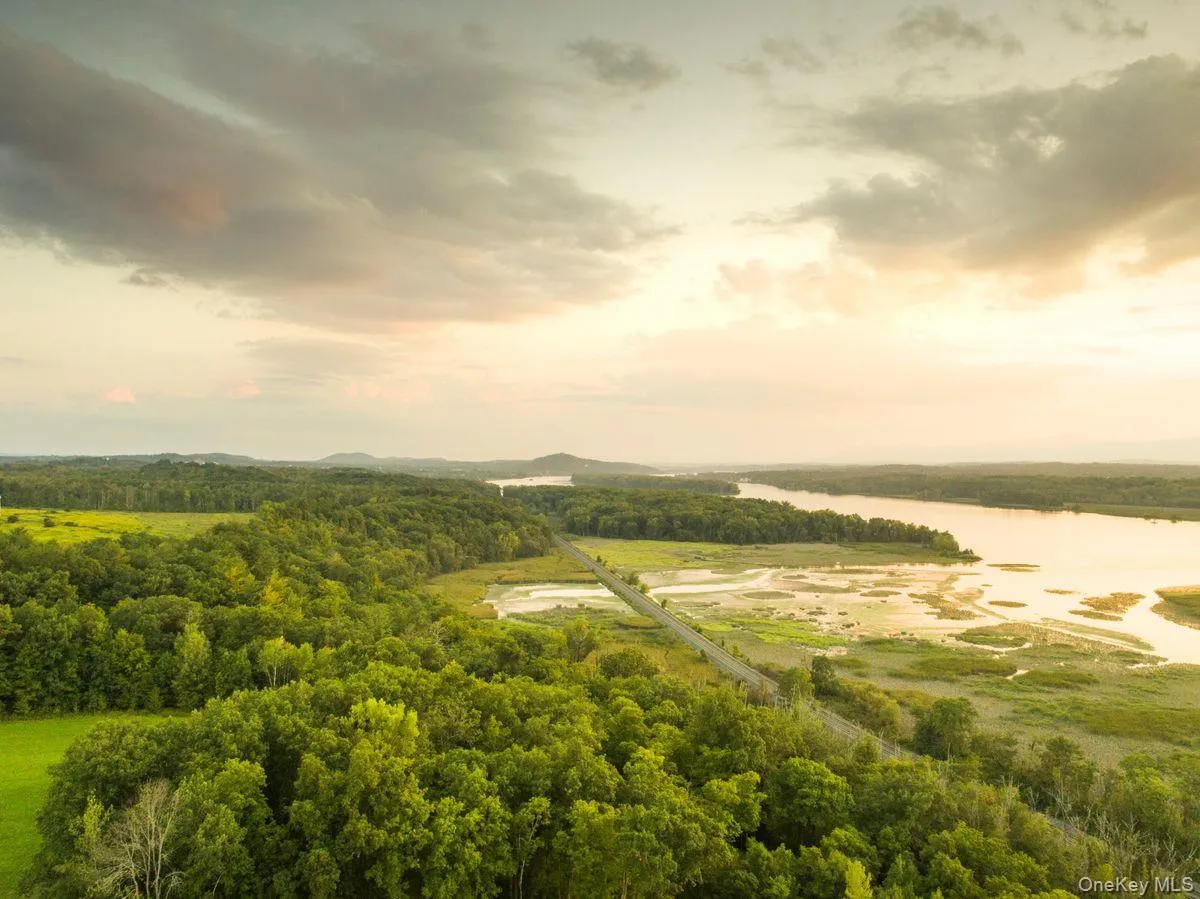 Aerial view at dusk featuring a water view Aerial view at dusk featuring a water view