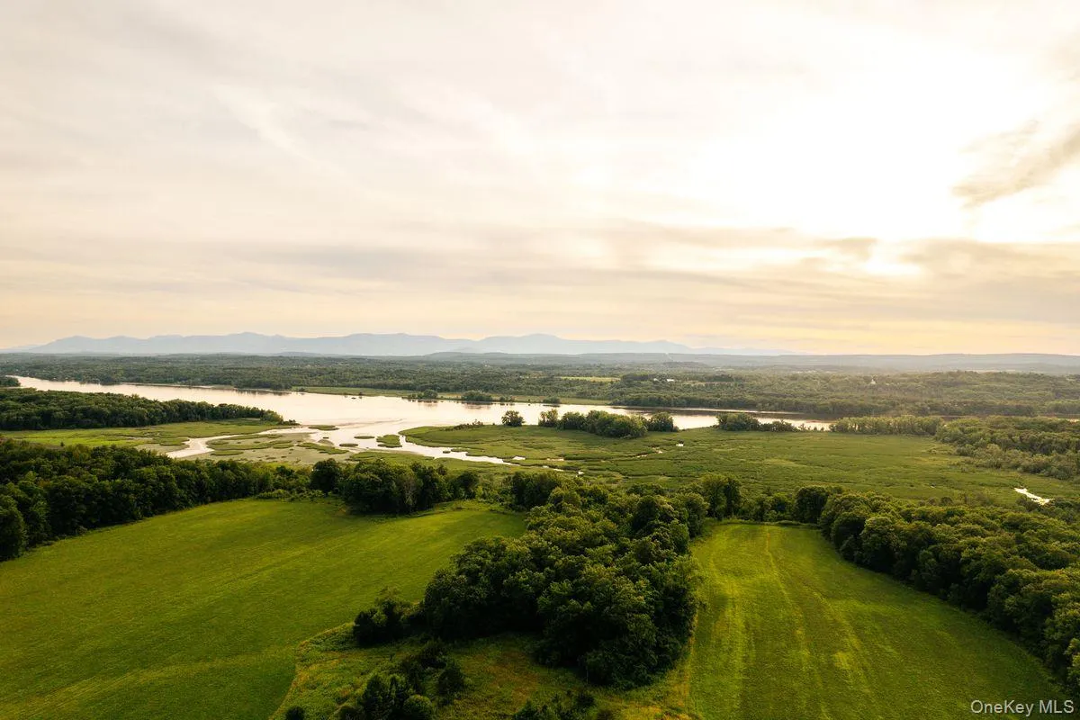 Aerial view featuring a water and mountain view Aerial view featuring a water and mountain view