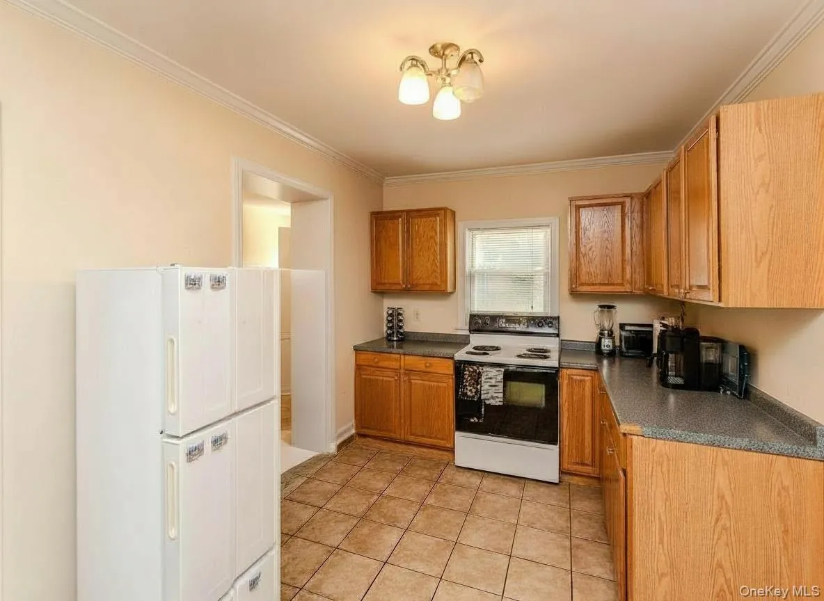 Kitchen with oak wood cabinets and ceramic tile floors Kitchen with oak wood cabinets and ceramic tile floors