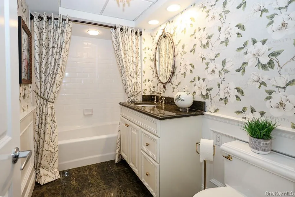 Hall Bathroom w/custom cabinetry & granite counters, and beautiful luxury tiled bath/shower, designer wall paper. Hall Bathroom w/custom cabinetry & granite counters, and beautiful luxury tiled bath/shower, designer wall paper.