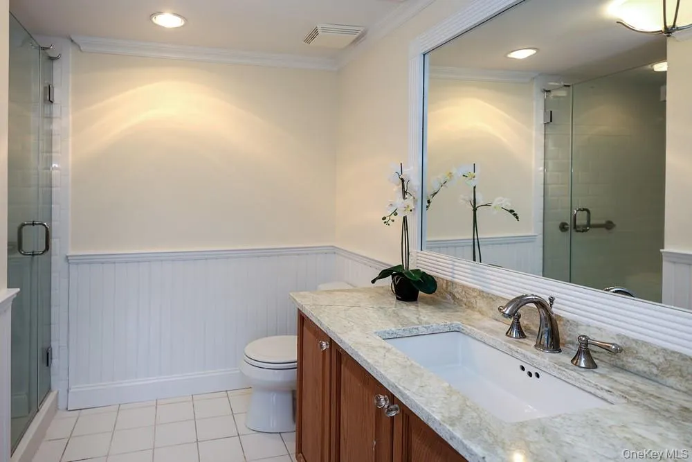 Ensuite bath to Bedroom #3 with walk-in shower, custom cabinetry, beautiful moldings and stone counters. Ensuite bath to Bedroom #3 with walk-in shower, custom cabinetry, beautiful moldings and stone counters.
