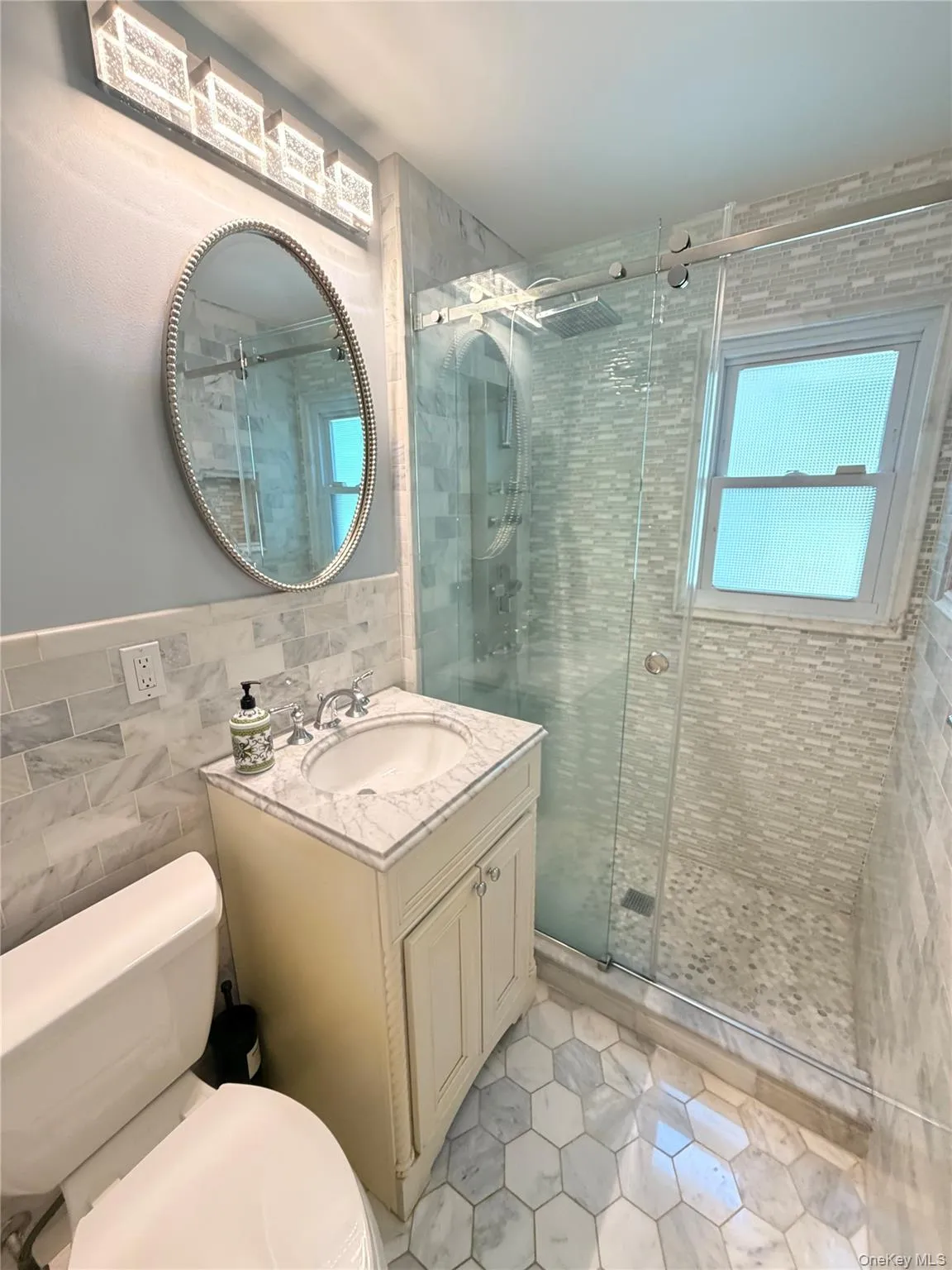 First floor hall bath with shower in sophisticated neutral tones First floor hall bath with shower in sophisticated neutral tones