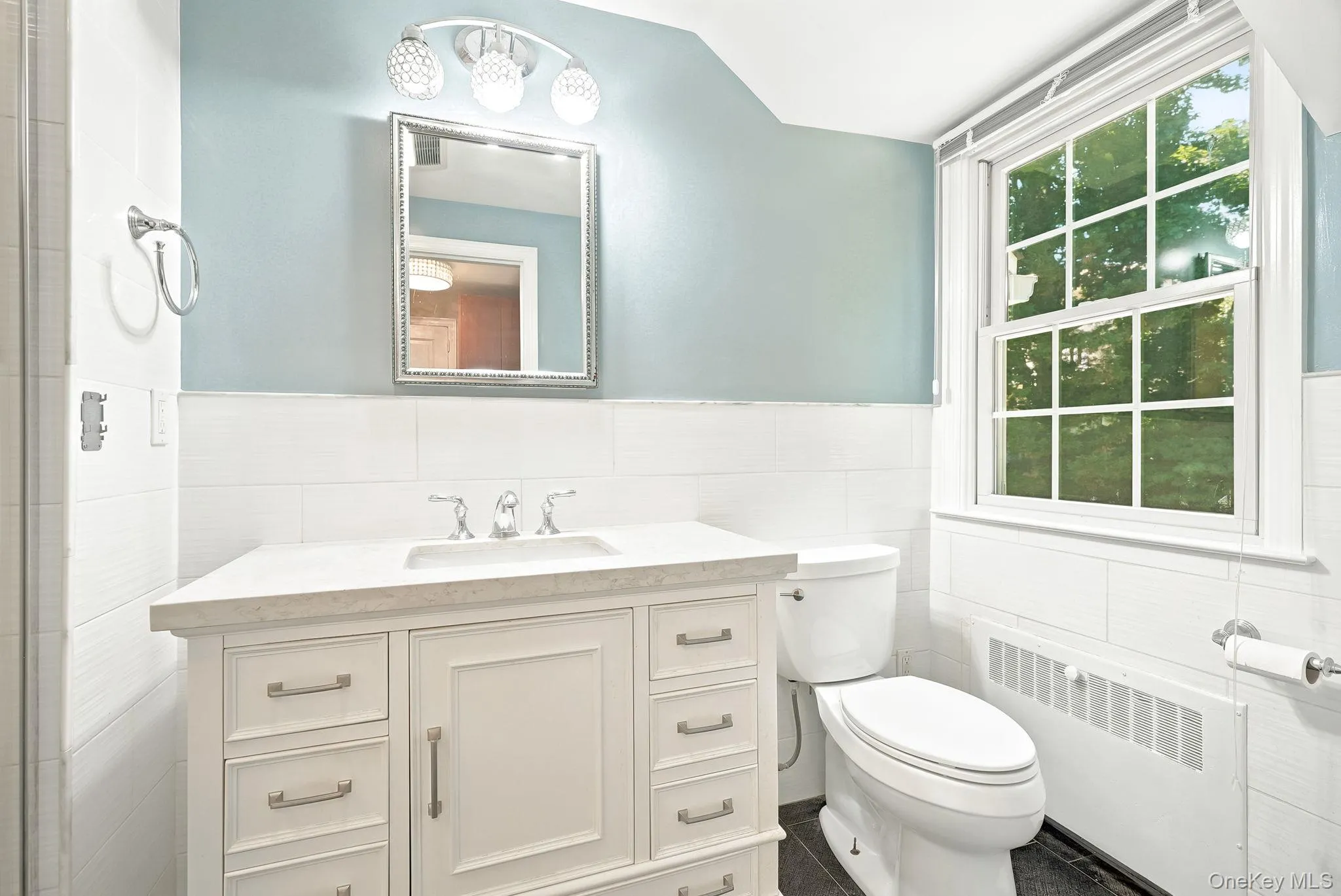 Tranquil primary bath with window overlooking private yard Tranquil primary bath with window overlooking private yard