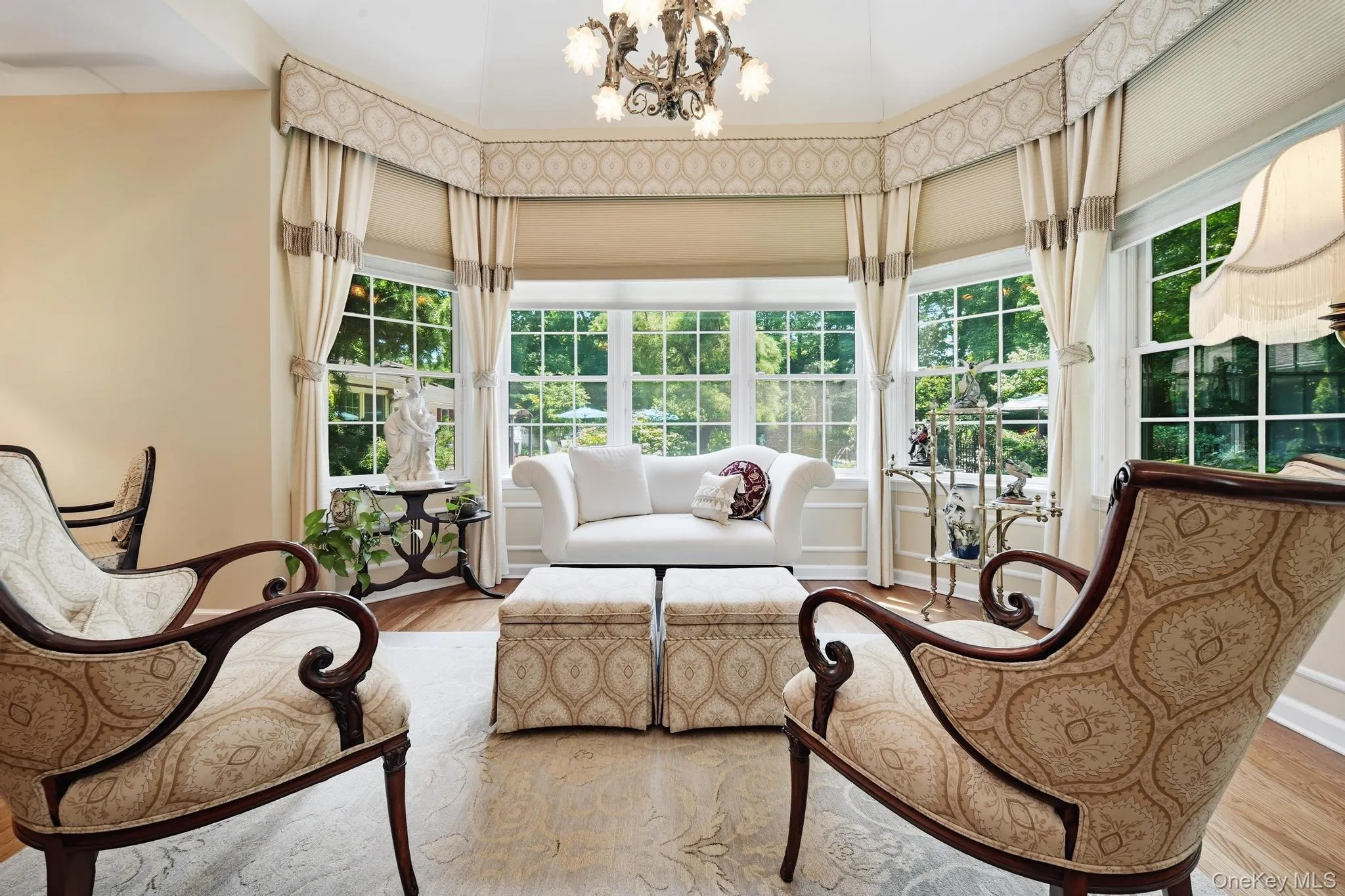Bright sunroom featuring a bay window with custom valances and draperies Bright sunroom featuring a bay window with custom valances and draperies