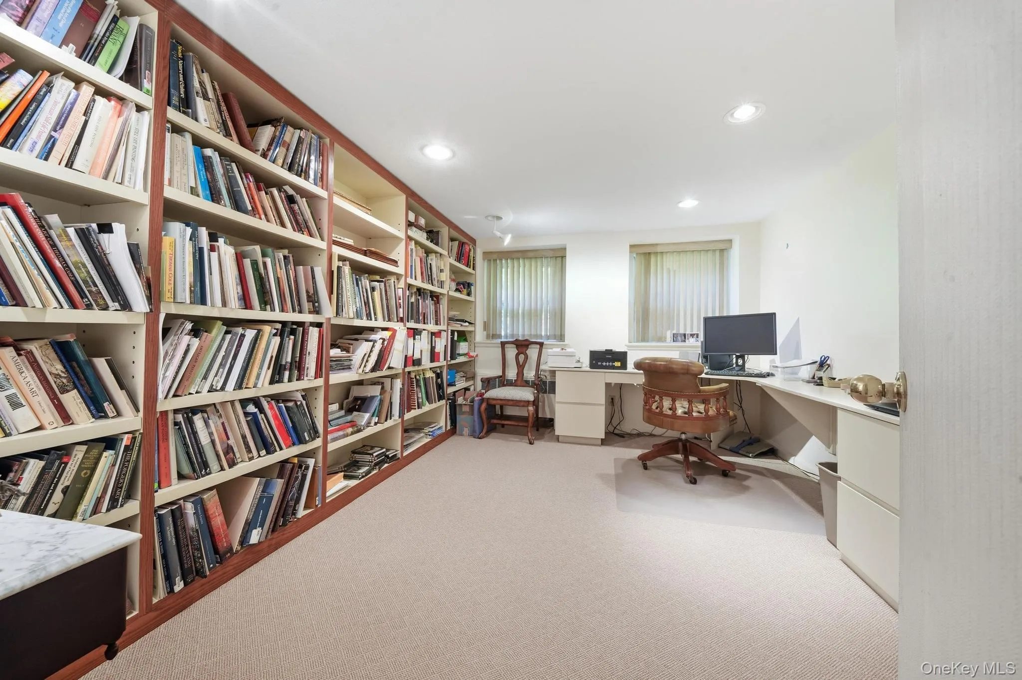 Extensive built-in shelving with wood-finish trim, plush carpet flooring, recessed lighting, and dual windows Extensive built-in shelving with wood-finish trim, plush carpet flooring, recessed lighting, and dual windows