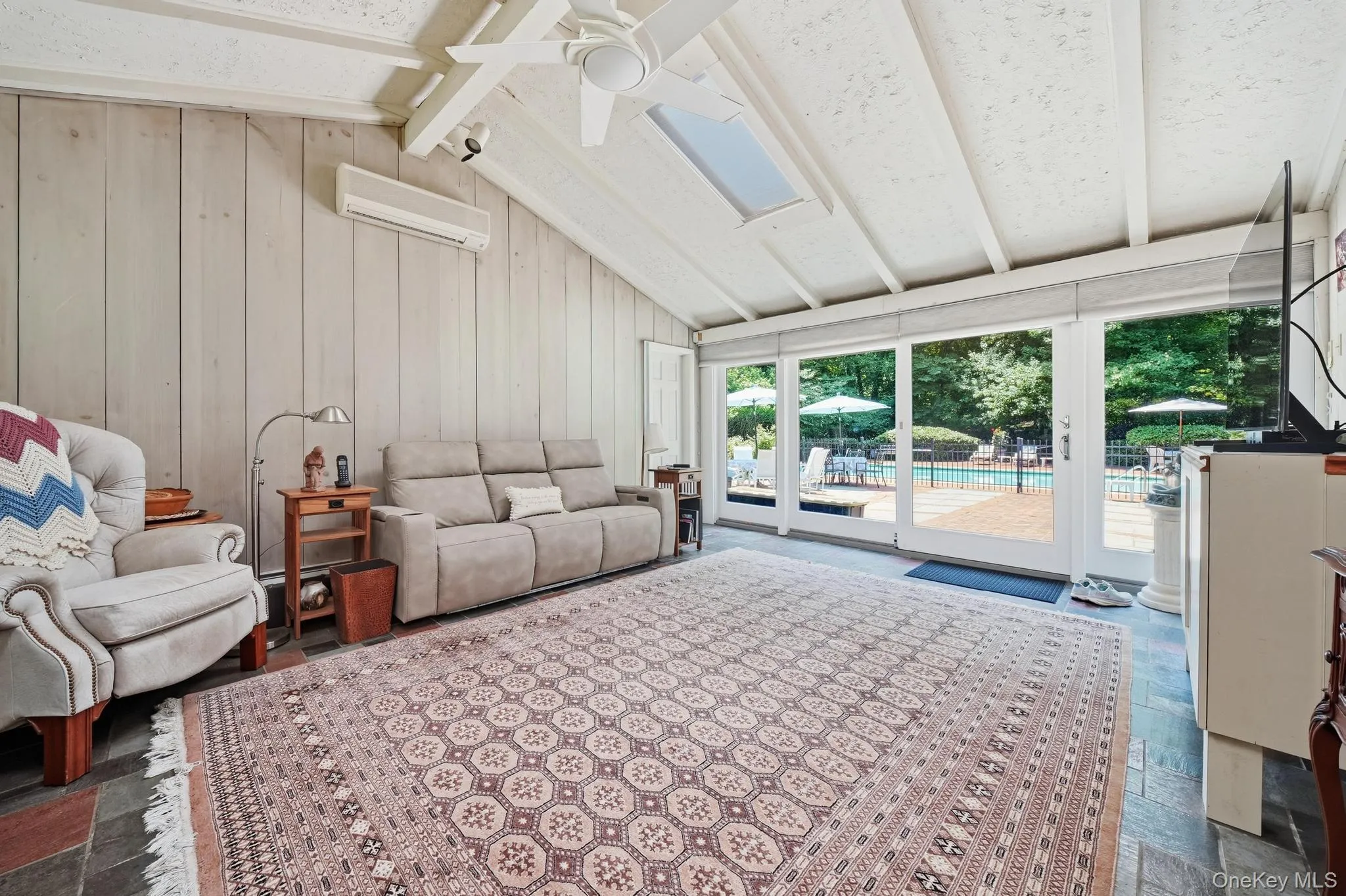 Vaulted ceiling interior space with exposed beams and wood-paneled walls Vaulted ceiling interior space with exposed beams and wood-paneled walls