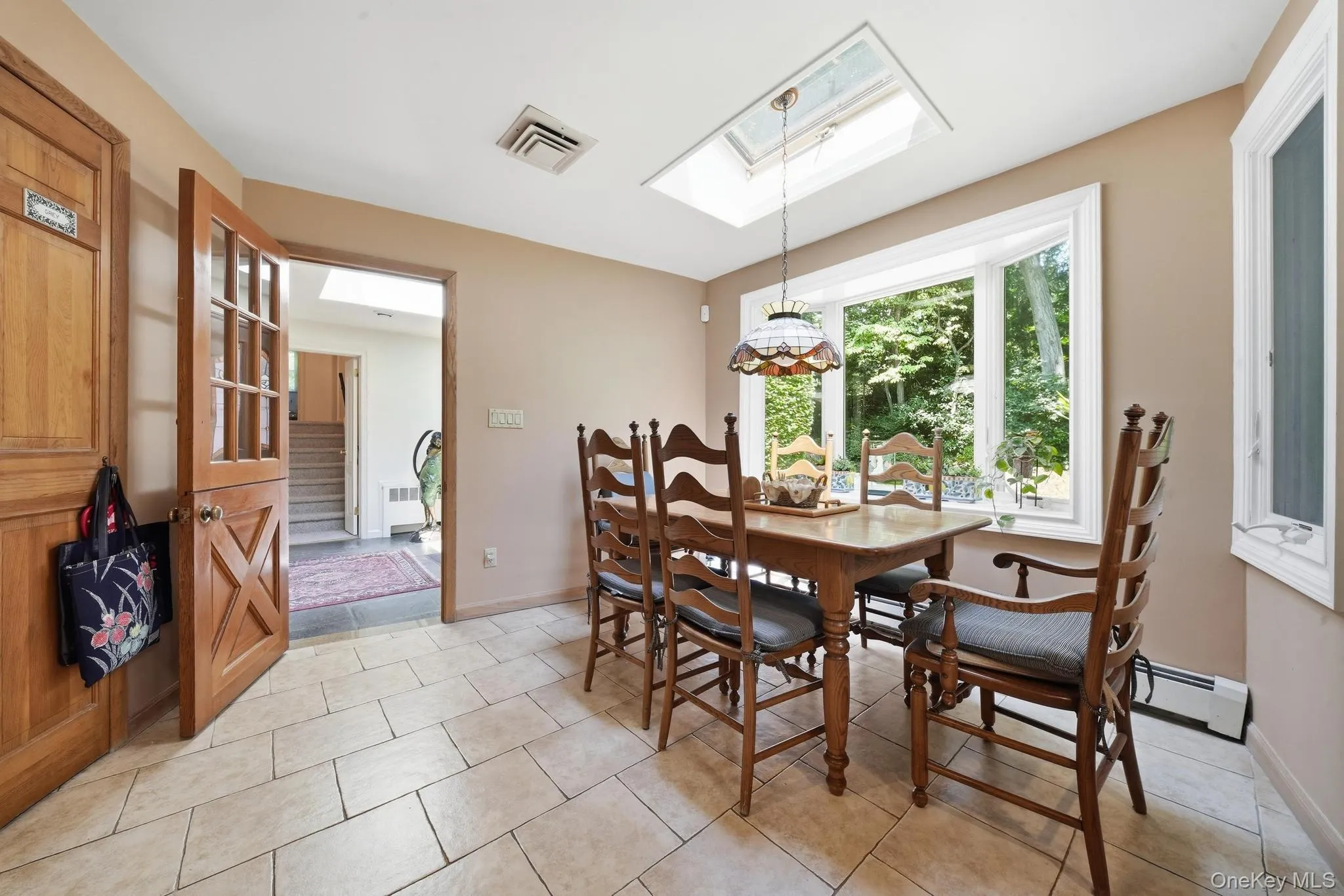 Dining area featuring a skylight, transom window, and a bay window Dining area featuring a skylight, transom window, and a bay window
