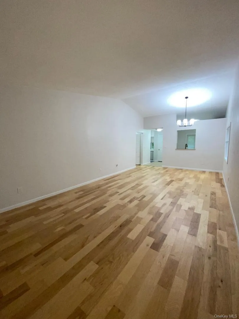 Huge living room with cathedral ceilings, a dining area and wood floors throughout Huge living room with cathedral ceilings, a dining area and wood floors throughout