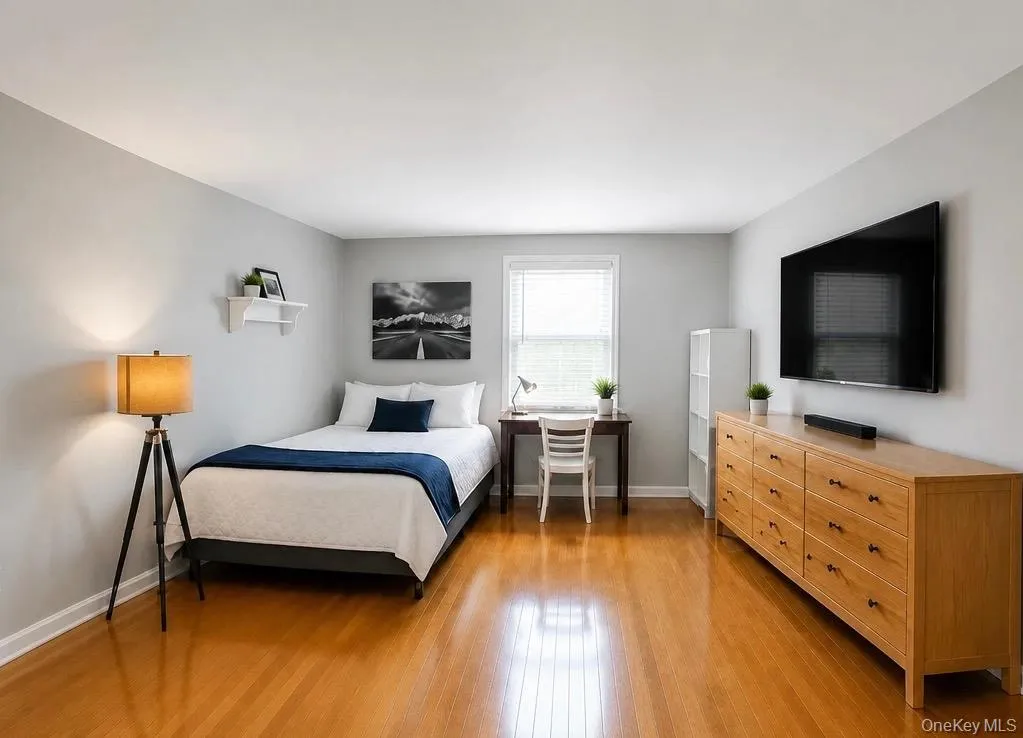 Bedroom featuring wood-finish flooring Bedroom featuring wood-finish flooring