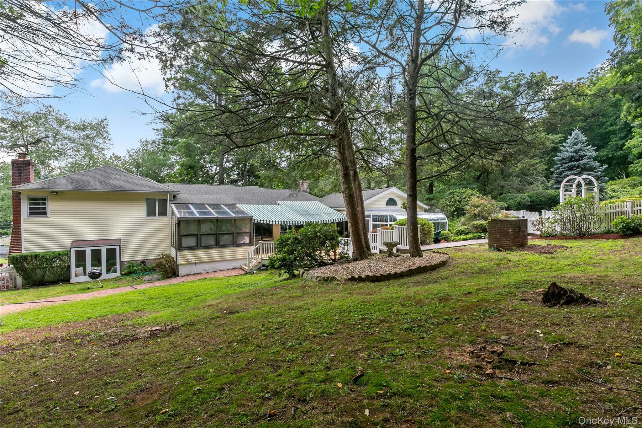 Private Back Yard with Pool tucked behind the white arbor fence Private Back Yard with Pool tucked behind the white arbor fence