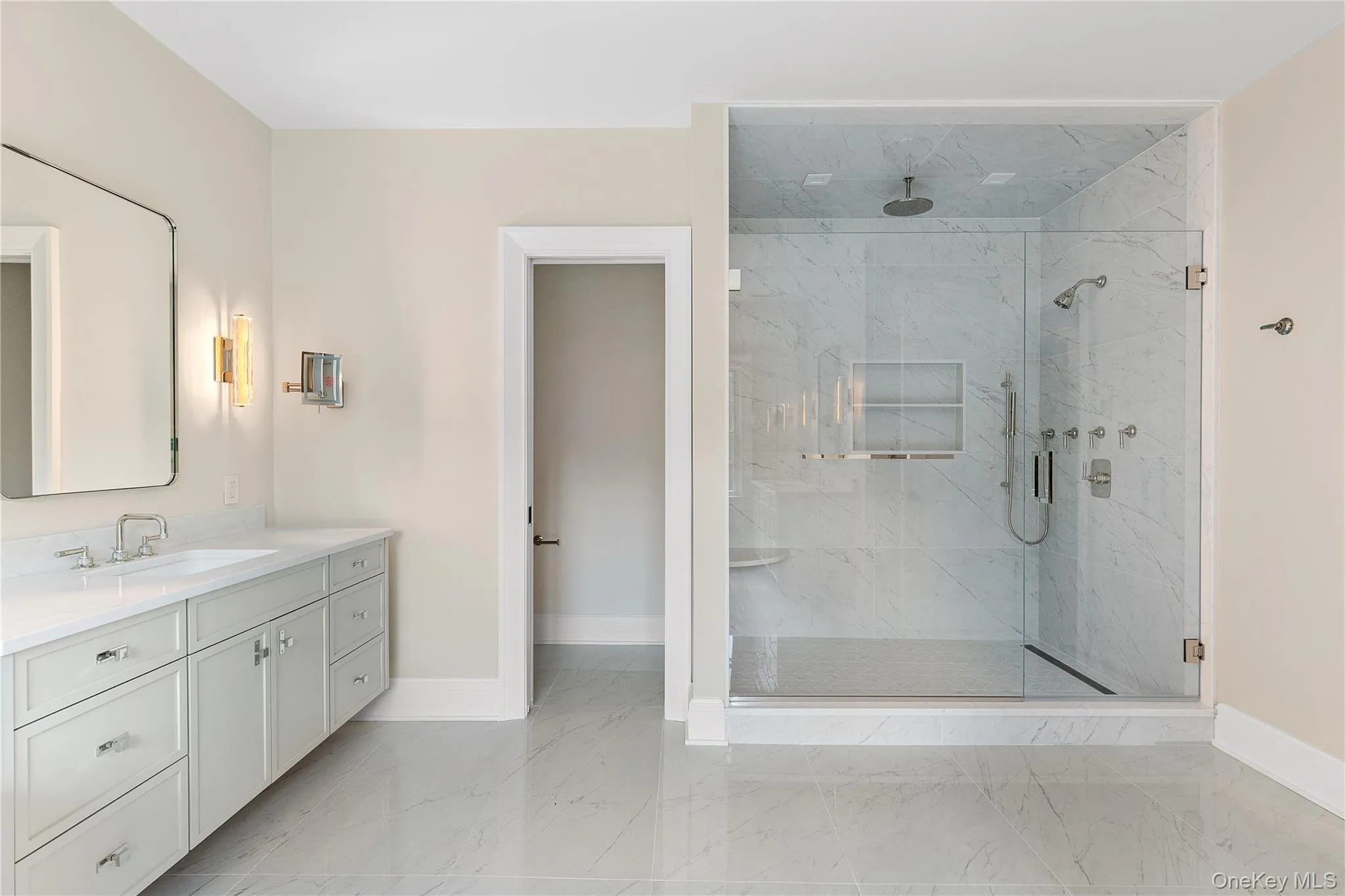 The spa-inspired primary bath is thoughtfully designed with dual vanities, a freestanding soaking tub, an oversized glass-enclosed shower, and a private water closet. The spa-inspired primary bath is thoughtfully designed with dual vanities, a freestanding soaking tub, an oversized glass-enclosed shower, and a private water closet.