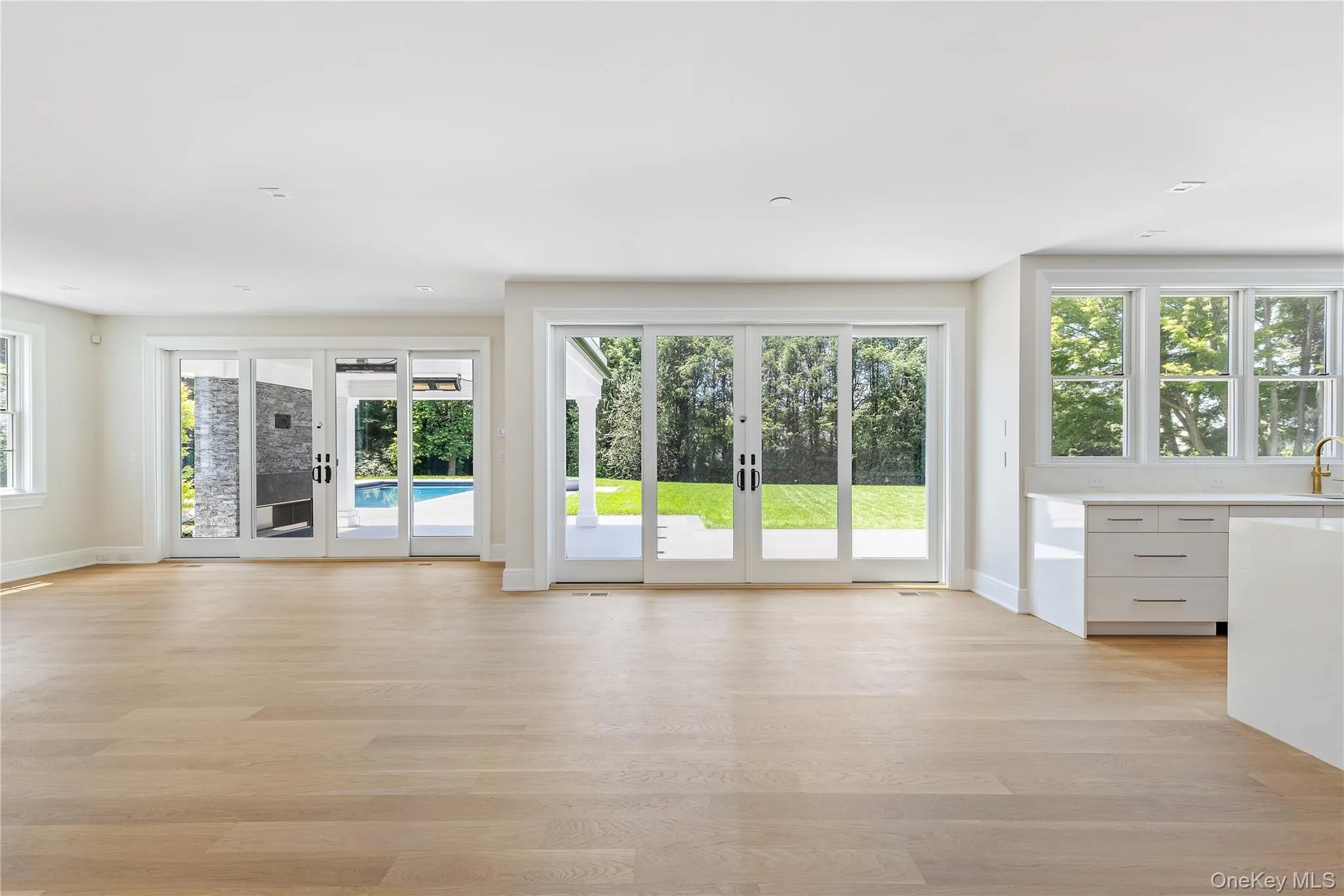 Walls of glass blur the line between indoors and out, opening the family room to the covered terrace, pool, and expansive backyard. Walls of glass blur the line between indoors and out, opening the family room to the covered terrace, pool, and expansive backyard.