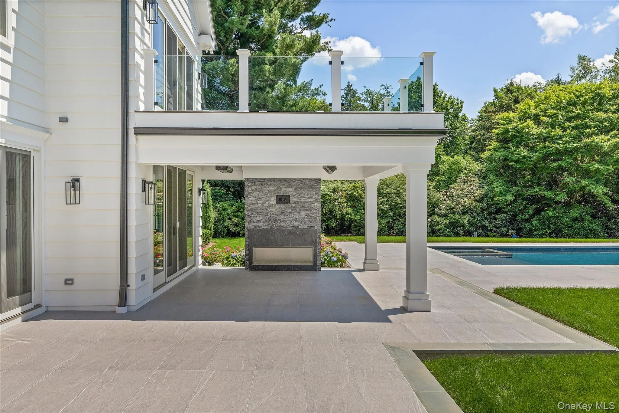 Enjoy al fresco living beneath the heated covered porch featuring a dramatic outdoor fireplace, ceiling heaters, and wiring for a flat screen tv, all just steps from the pool. Enjoy al fresco living beneath the heated covered porch featuring a dramatic outdoor fireplace, ceiling heaters, and wiring for a flat screen tv, all just steps from the pool.