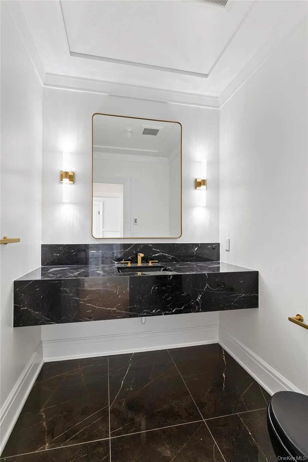 The elegant powder room showcases contemporary finishes and refined designer details for guests. The elegant powder room showcases contemporary finishes and refined designer details for guests.