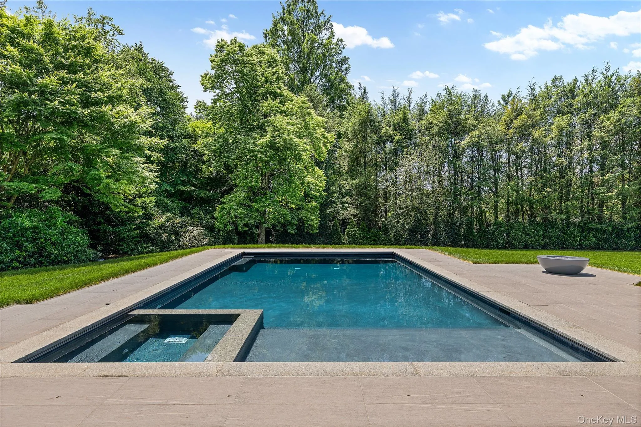 The stunning Gunite pool with integrated spa, sun shelf, and automatic cover creates your own private backyard retreat. The stunning Gunite pool with integrated spa, sun shelf, and automatic cover creates your own private backyard retreat.