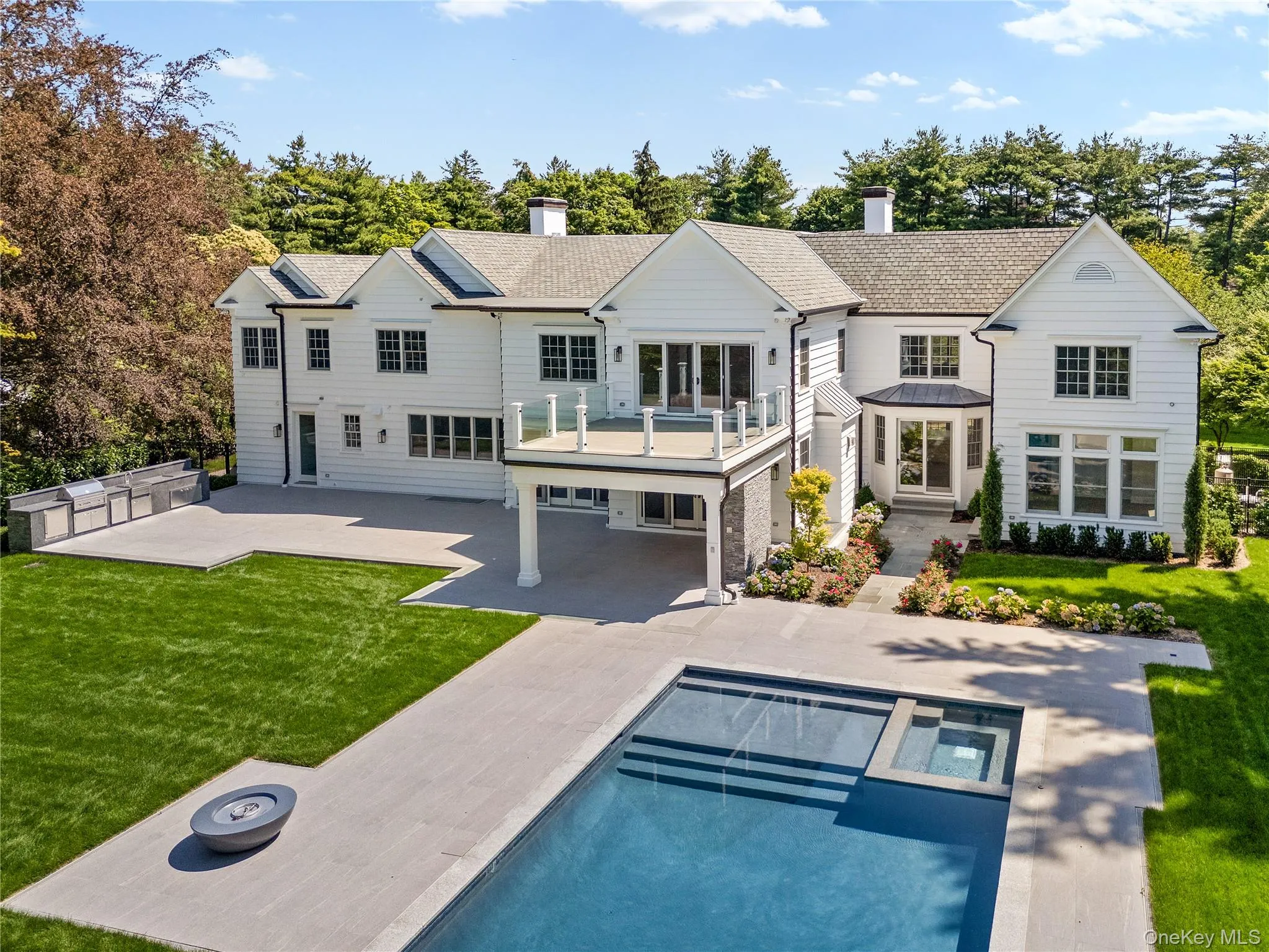 The rear elevation reveals seamless indoor-outdoor living with multiple entertaining areas overlooking the sparkling pool and private grounds. The rear elevation reveals seamless indoor-outdoor living with multiple entertaining areas overlooking the sparkling pool and private grounds.