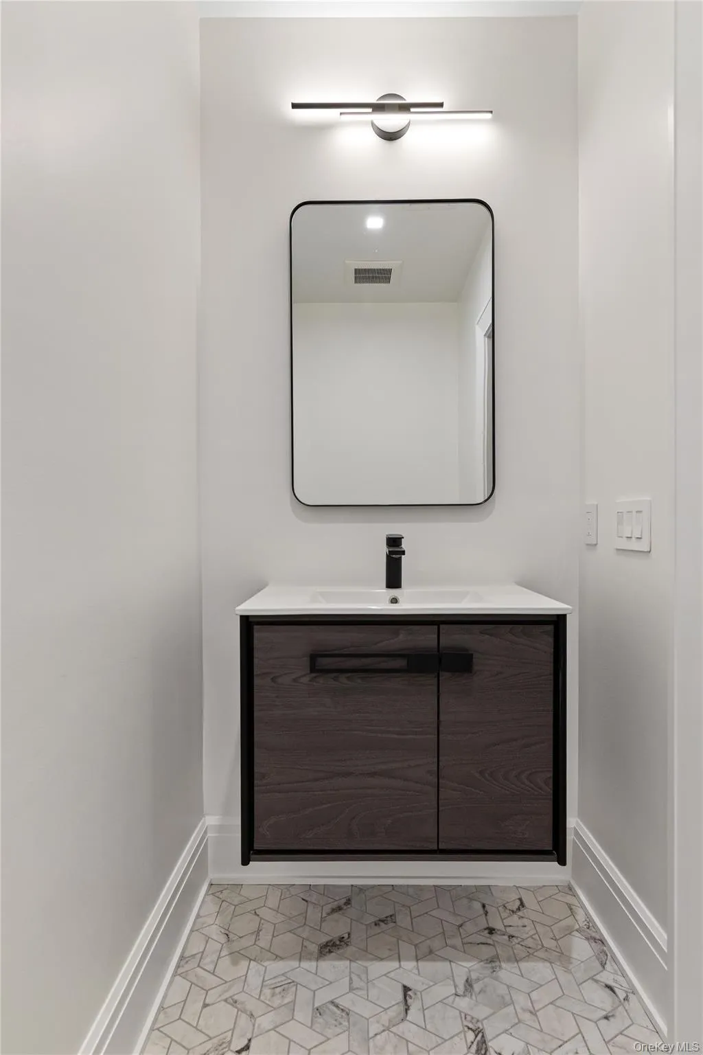 A beautifully finished powder room adds convenience for guests enjoying the home's lower-level amenities. A beautifully finished powder room adds convenience for guests enjoying the home's lower-level amenities.