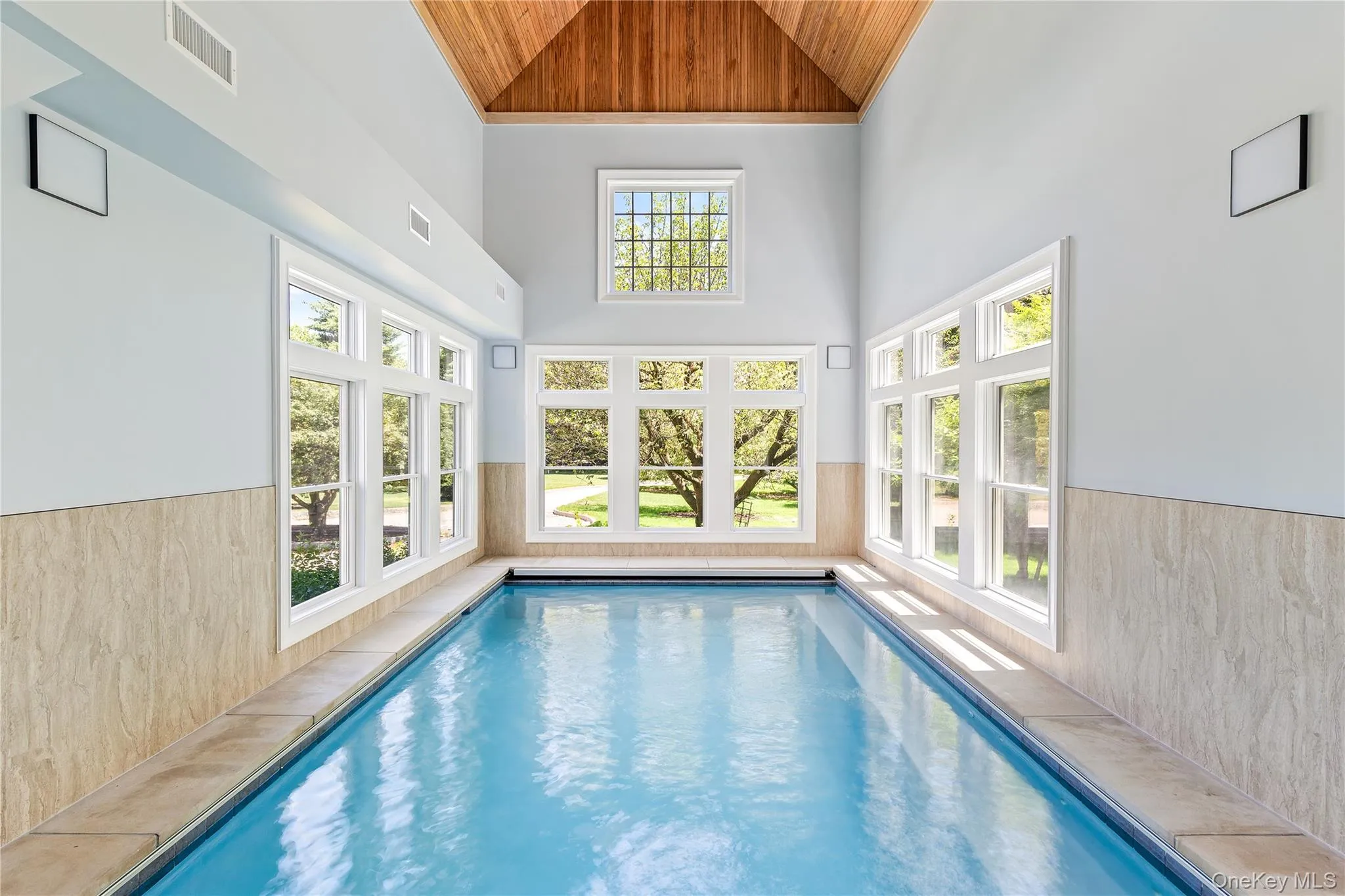 Your own year-round wellness retreat features a spectacular heated indoor pool with soaring vaulted wood ceilings, radiant heated floors, endless swim current, integrated spa, and abundant natural light from three exposures. Your own year-round wellness retreat features a spectacular heated indoor pool with soaring vaulted wood ceilings, radiant heated floors, endless swim current, integrated spa, and abundant natural light from three exposures.