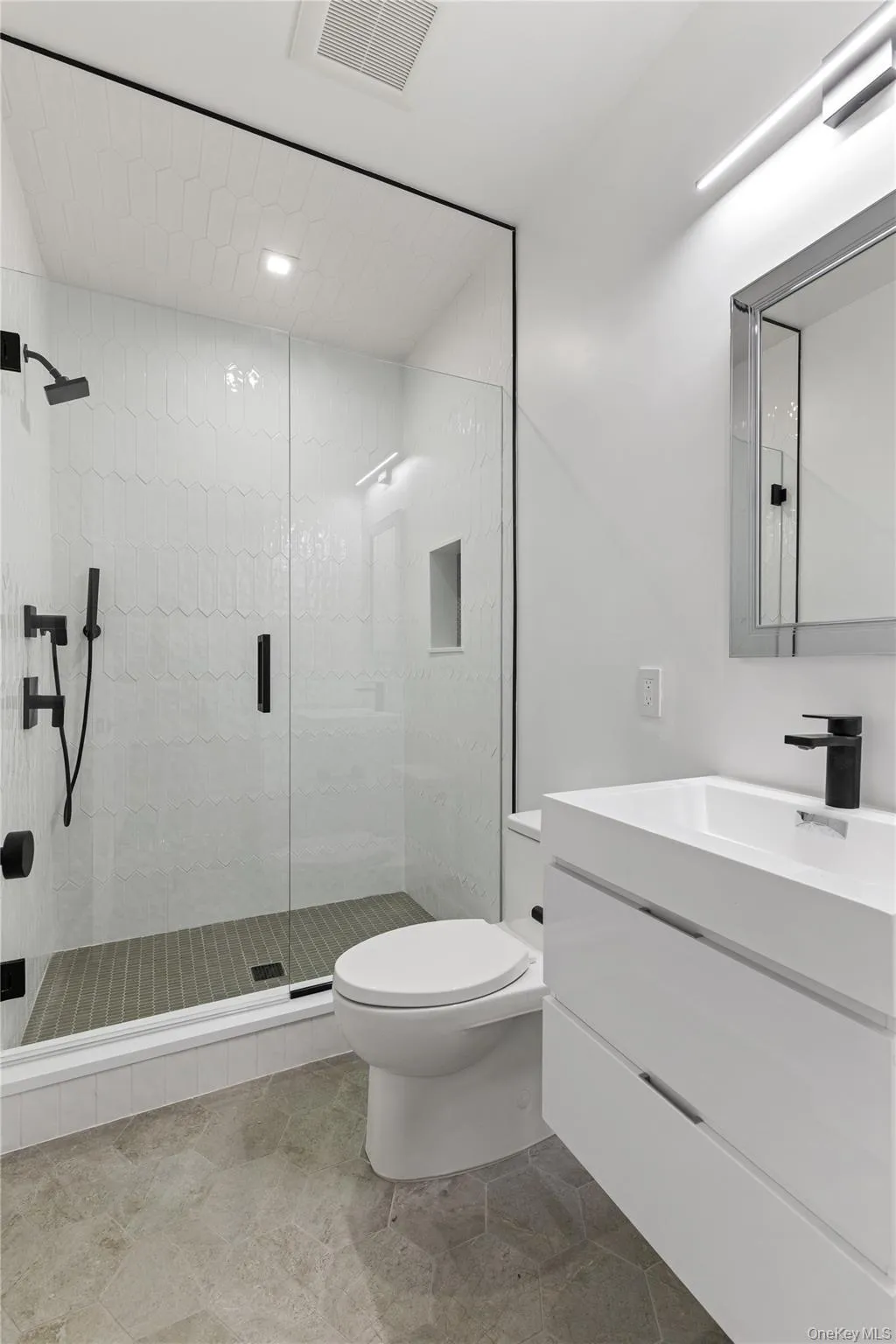 A modern full bath adjacent to the guest suite completes the lower level, offering privacy and comfort for family and visitors alike. A modern full bath adjacent to the guest suite completes the lower level, offering privacy and comfort for family and visitors alike.