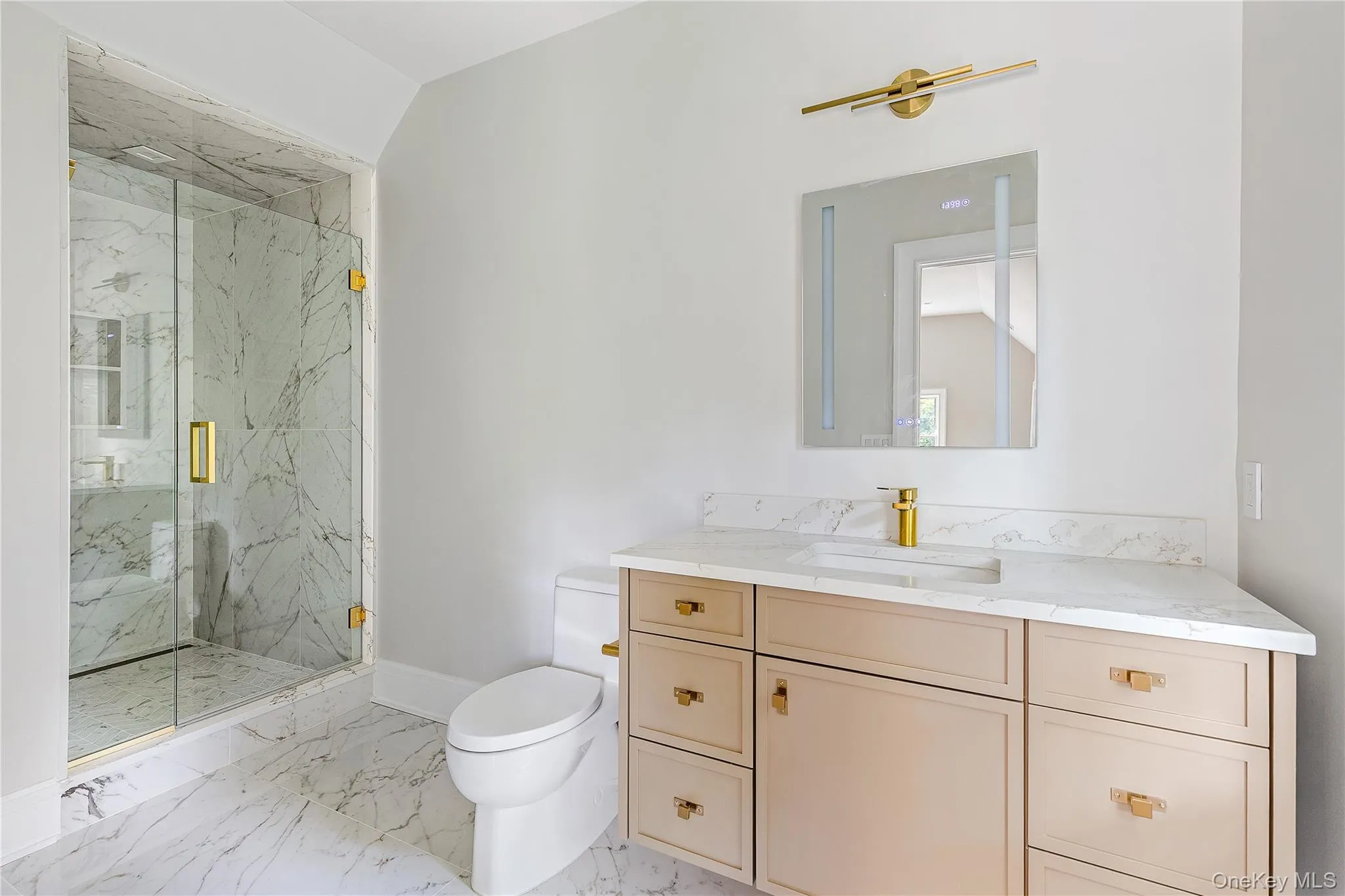 A beautifully appointed ensuite bath showcases timeless finishes, custom cabinetry, and a spacious glass-enclosed shower. A beautifully appointed ensuite bath showcases timeless finishes, custom cabinetry, and a spacious glass-enclosed shower.