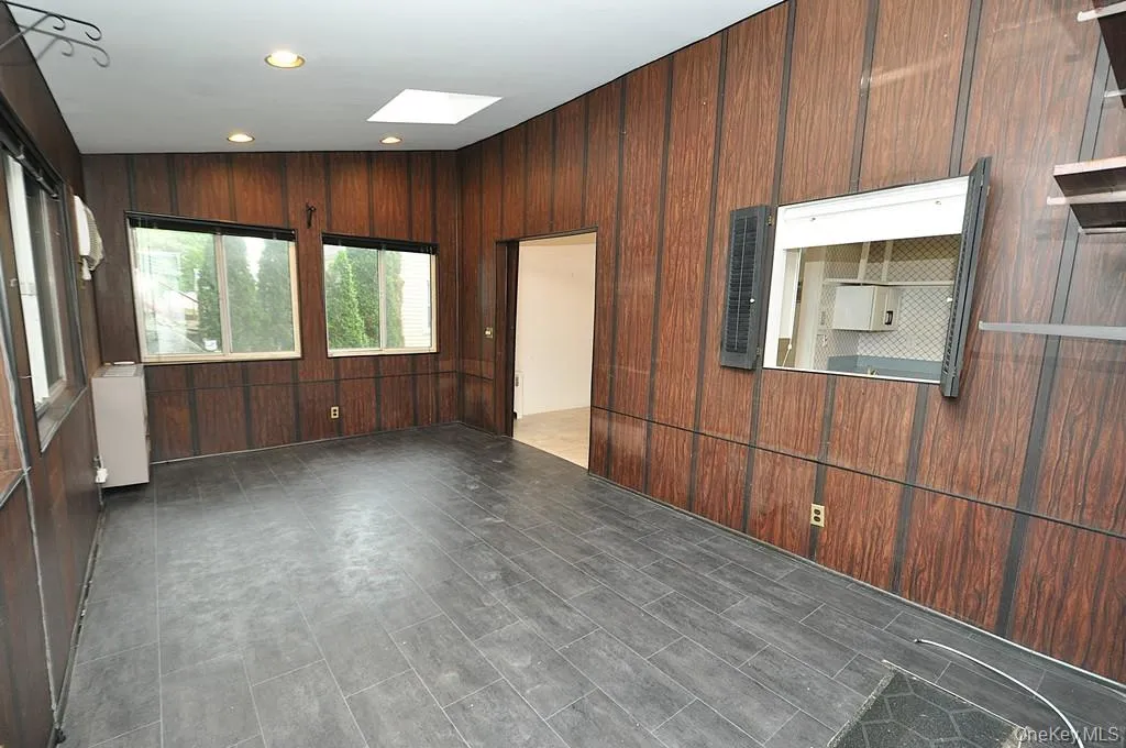 The enclosed back porch has two sky lights, a door leading to the back yard, pass thru to the kitchen and sliding doors leading to the dining room. The room is approx 17'-7" x 10'-0". The enclosed back porch has two sky lights, a door leading to the back yard, pass thru to the kitchen and sliding doors leading to the dining room. The room is approx 17'-7" x 10'-0".