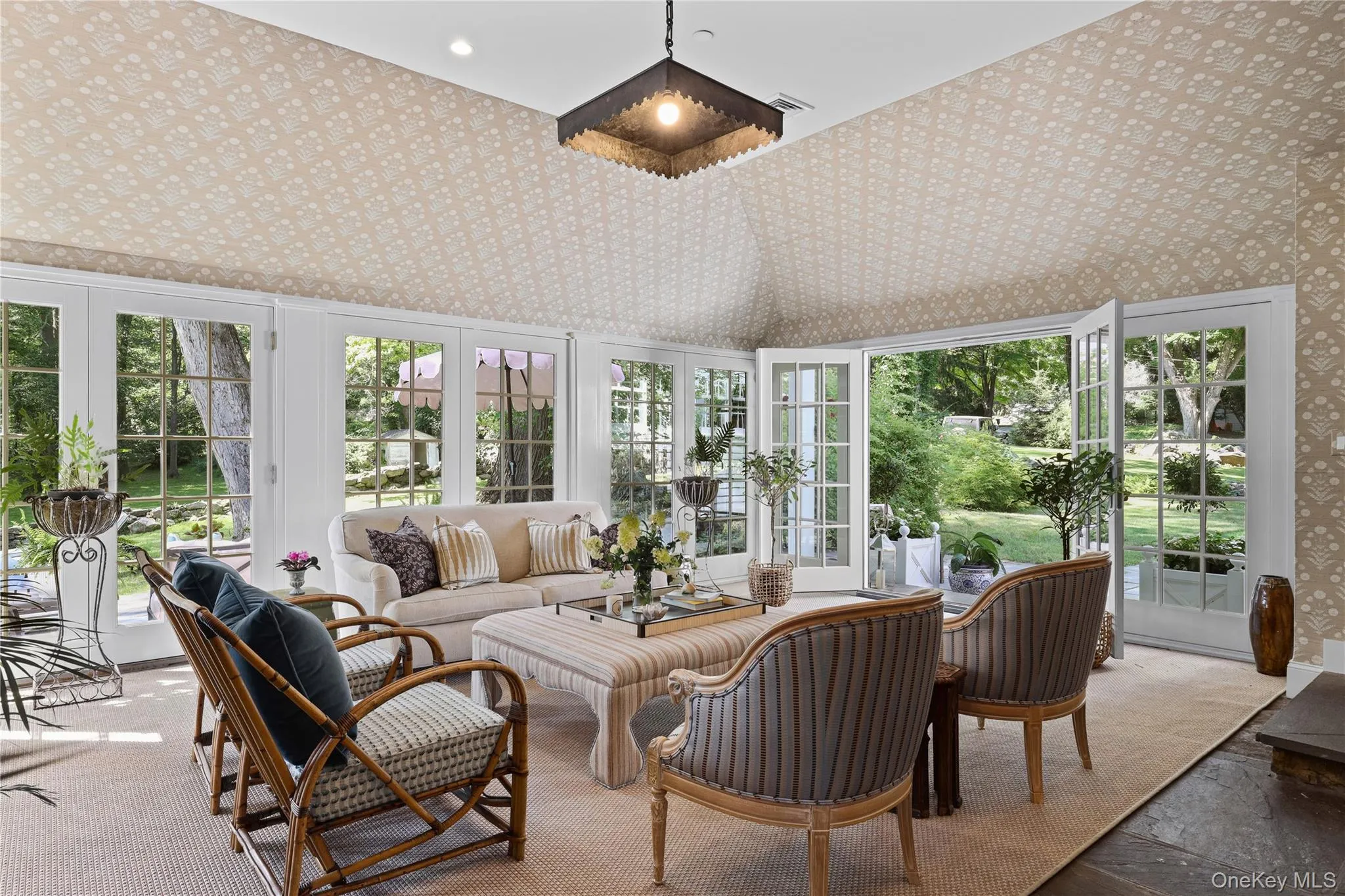 Sun-filled sunroom which opens to the patio Sun-filled sunroom which opens to the patio