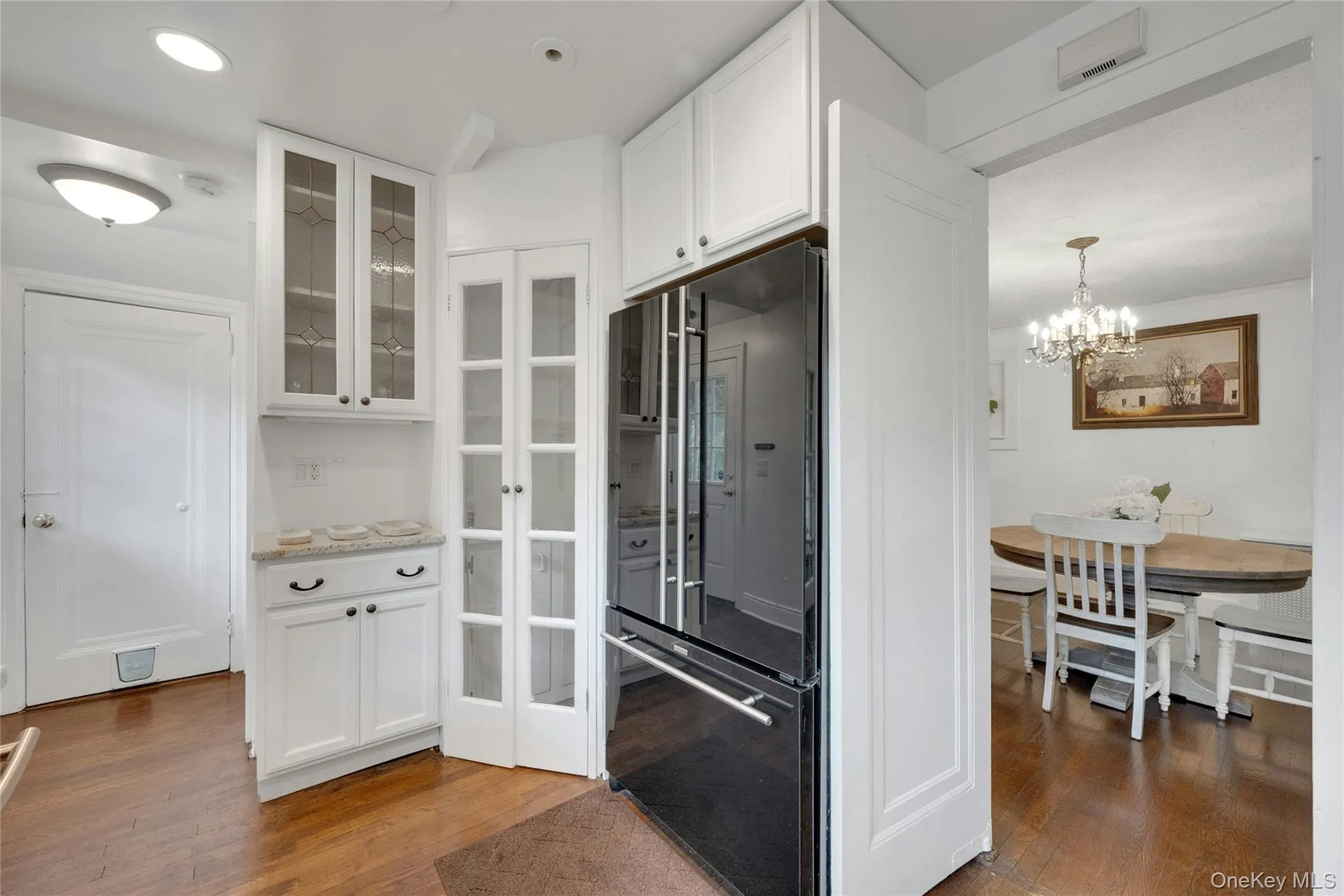 View into the dining room and side hallway with access to the basement. View into the dining room and side hallway with access to the basement.