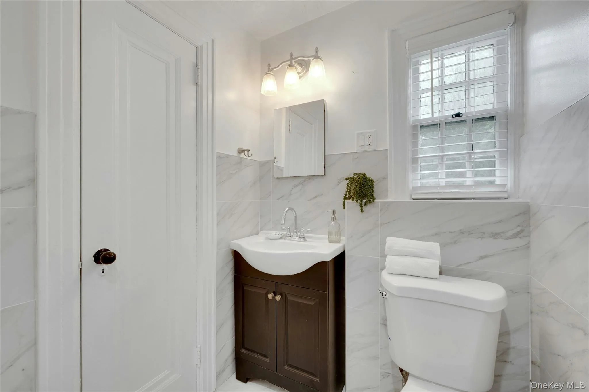 Hall bathroom with standing shower with glass doors. Hall bathroom with standing shower with glass doors.