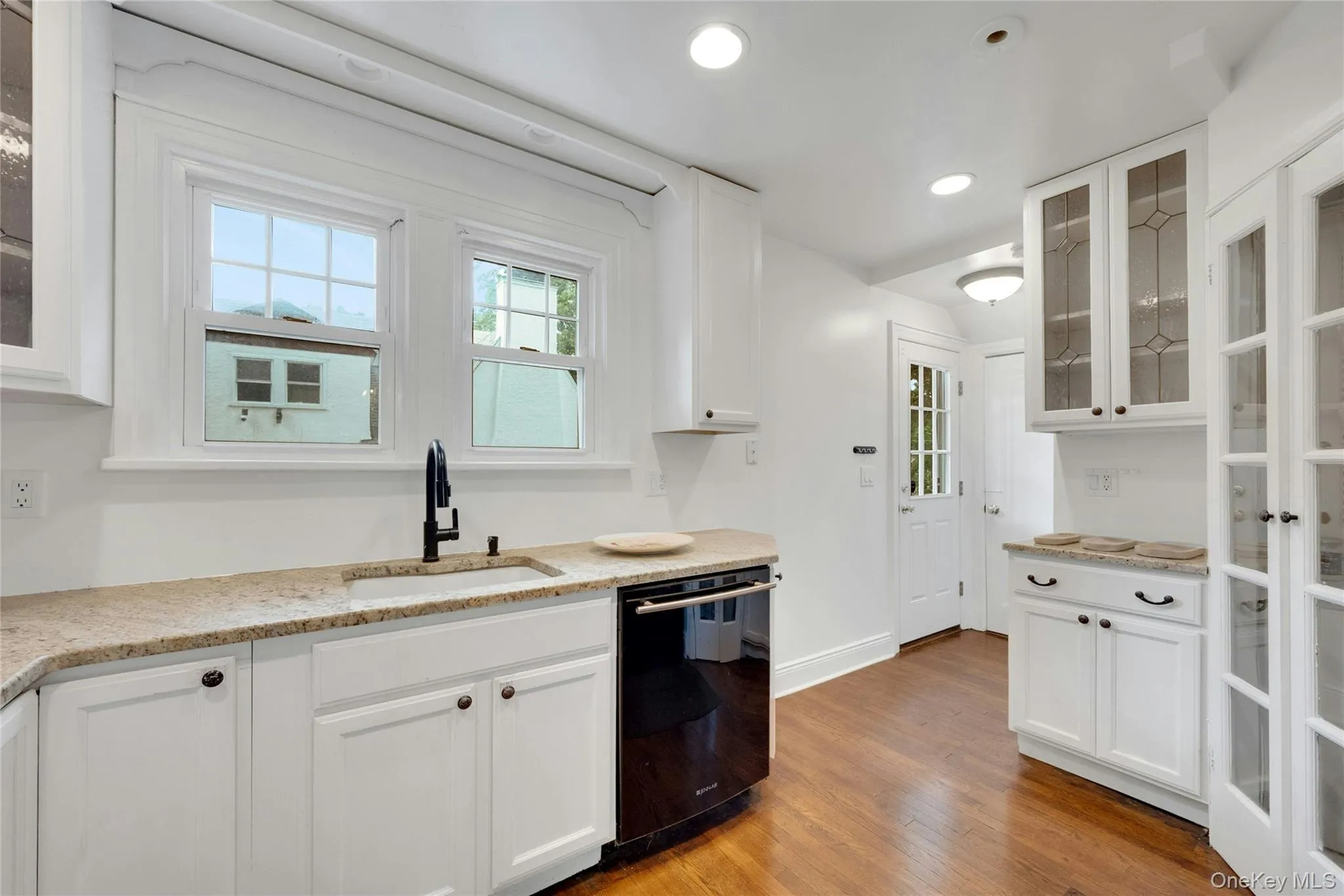 Kitchen with French doors to generous pantry- open flow with easy access to both the living room and dining room. Kitchen with French doors to generous pantry- open flow with easy access to both the living room and dining room.