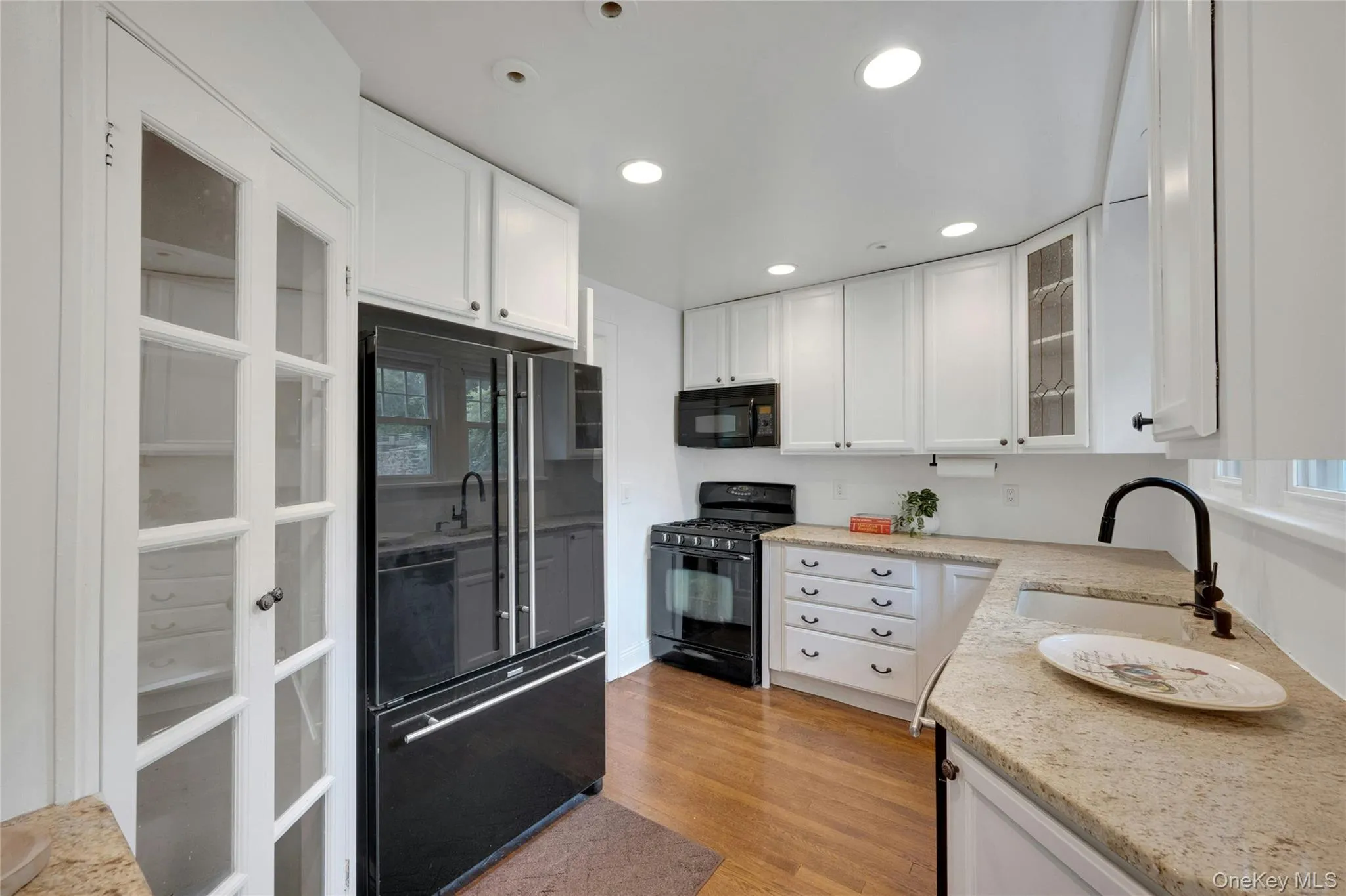 Kitchen with gas range, built in microwave, dishwasher, double wide refrigerator with freezer draw botto,. Kitchen with gas range, built in microwave, dishwasher, double wide refrigerator with freezer draw botto,.