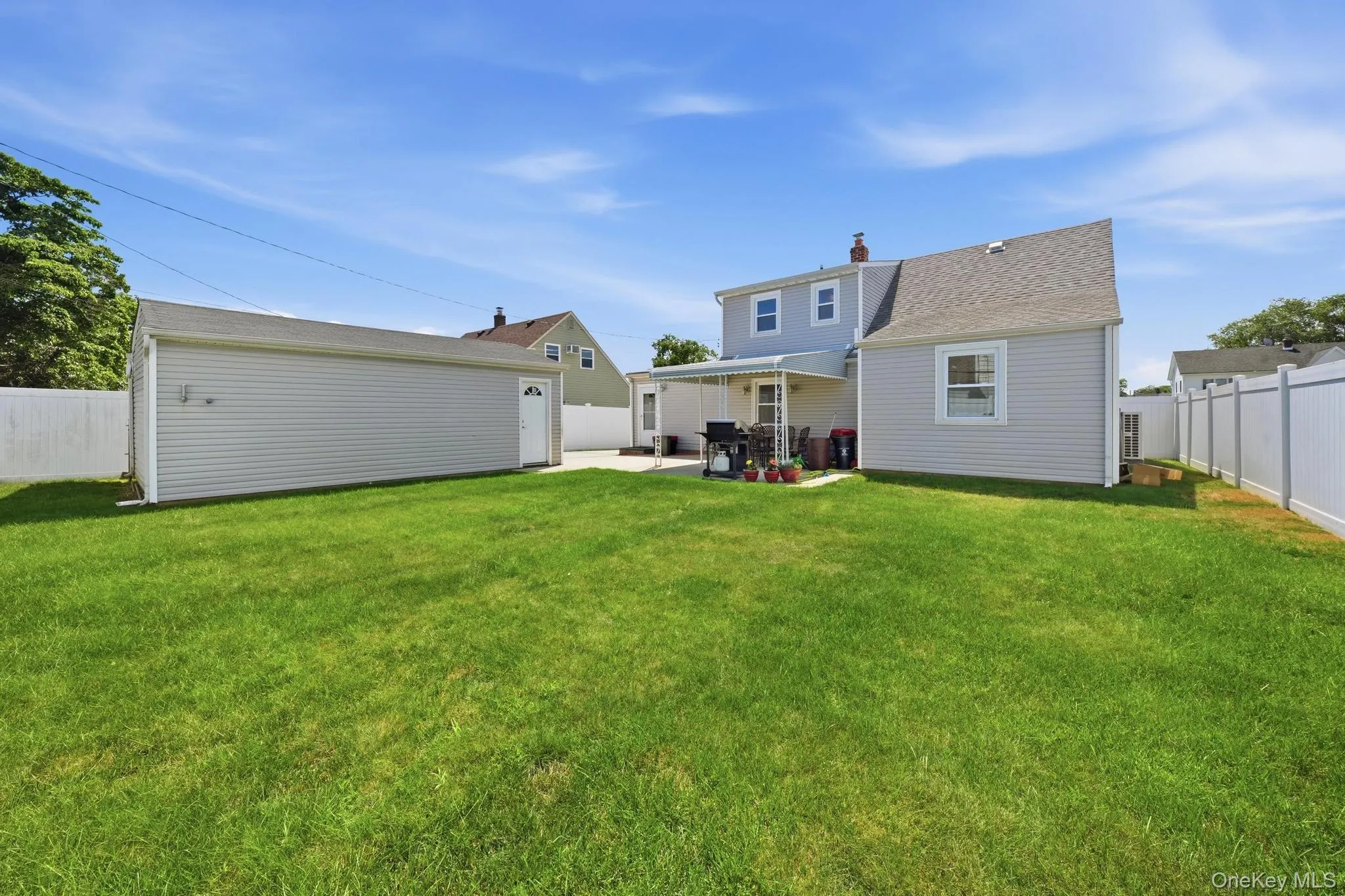 Expansive green lawn with a privacy fence Expansive green lawn with a privacy fence