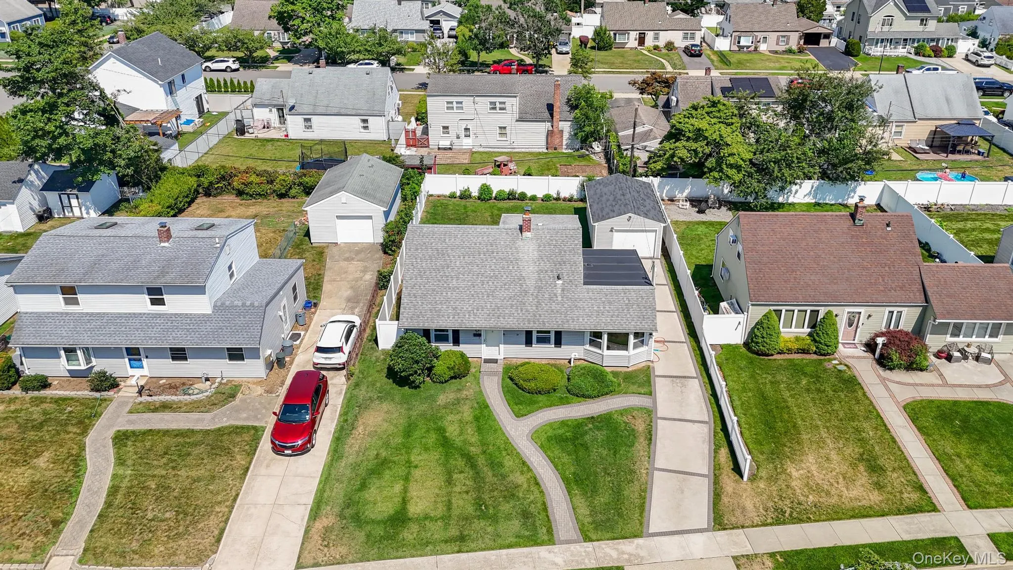 Single-story residence featuring a gray shingle roof and a bay window Single-story residence featuring a gray shingle roof and a bay window