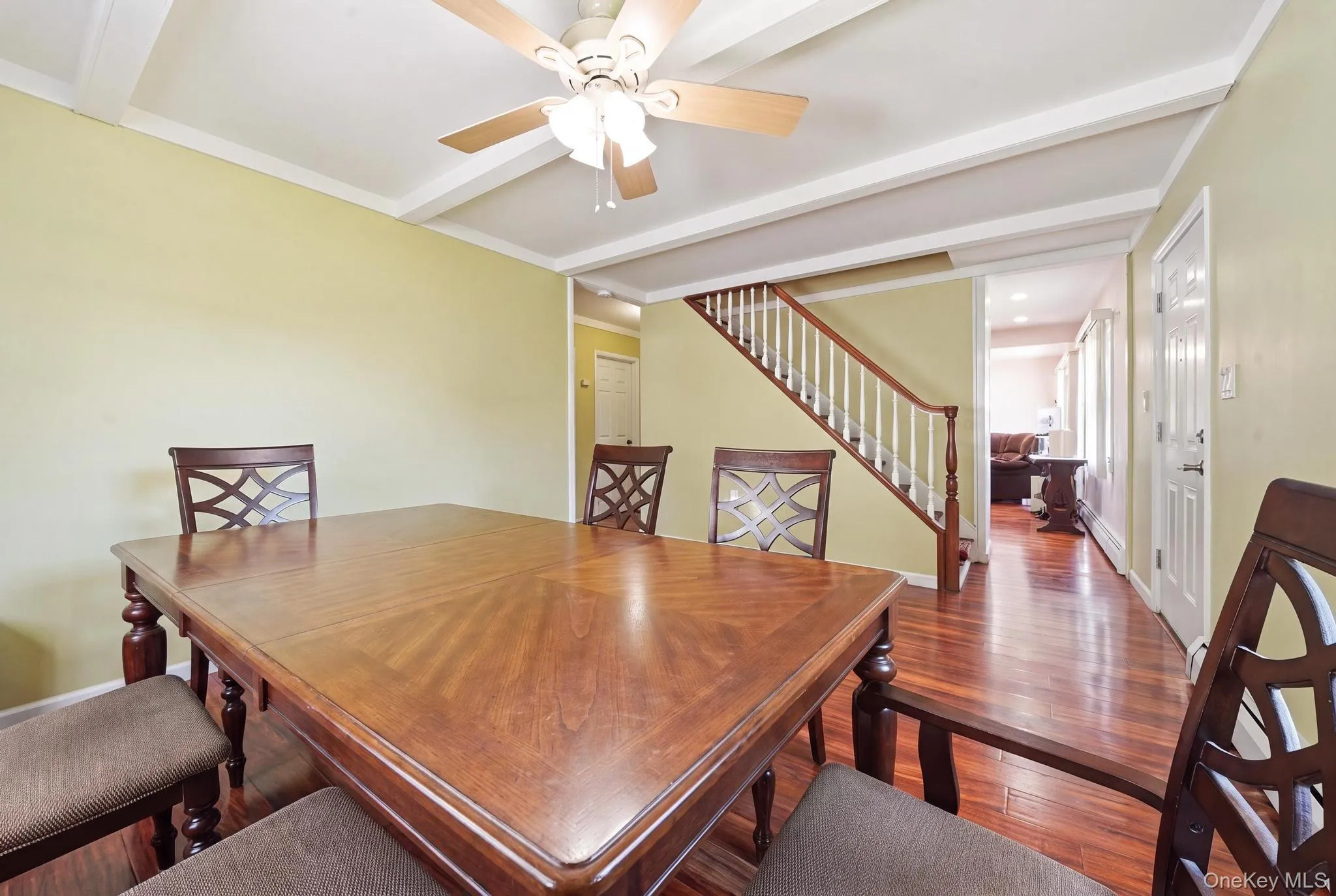 Dining area with rich wood-finish flooring and a wood ceiling fan Dining area with rich wood-finish flooring and a wood ceiling fan