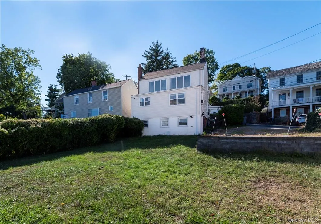 Rear view of house featuring a lawn Rear view of house featuring a lawn