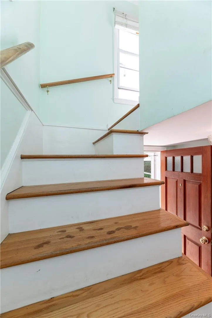 Stairs with hardwood / wood-style flooring and a healthy amount of sunlight Stairs with hardwood / wood-style flooring and a healthy amount of sunlight