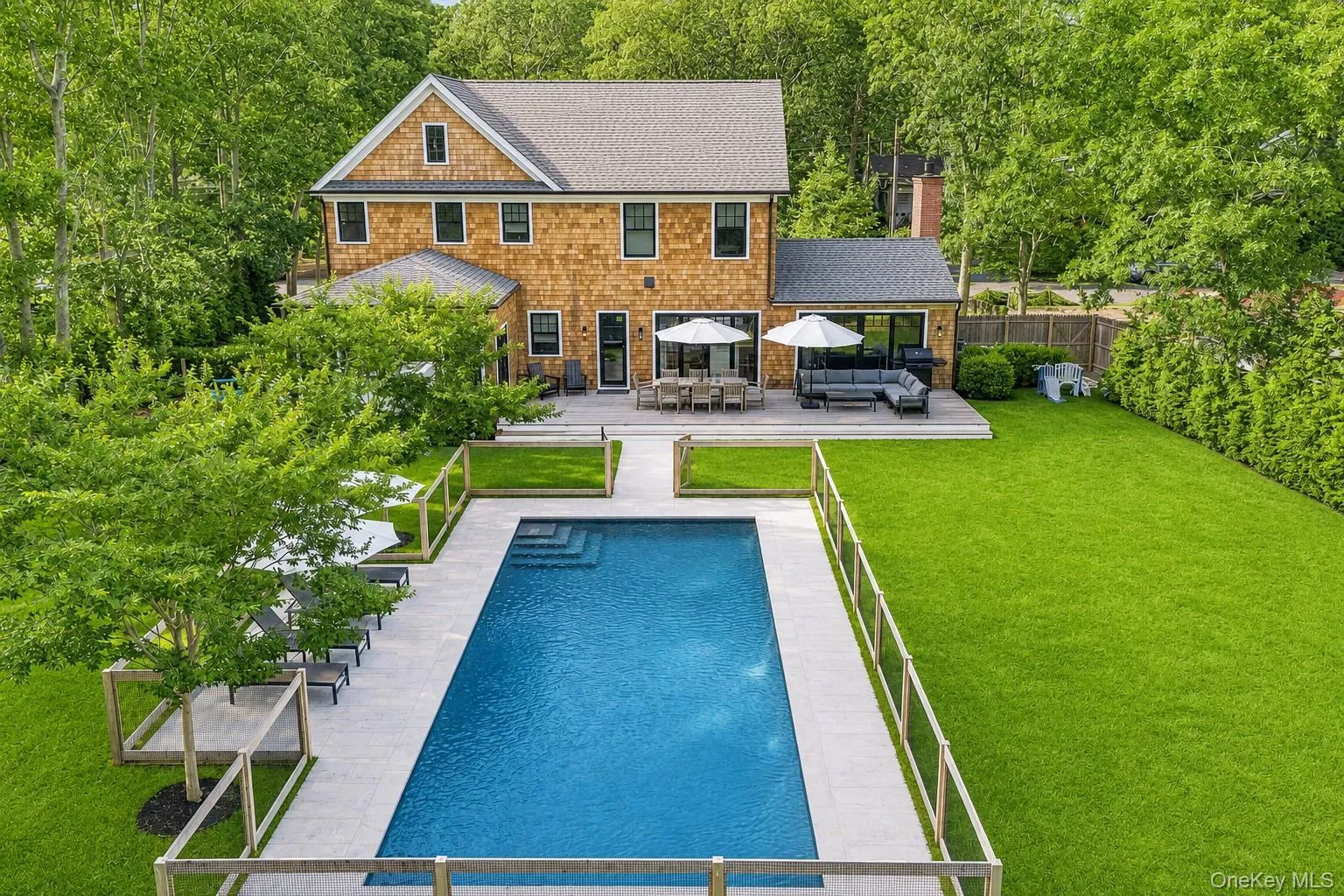 Shingle-sided residence featuring a gray shingle roof and black-framed windows Shingle-sided residence featuring a gray shingle roof and black-framed windows