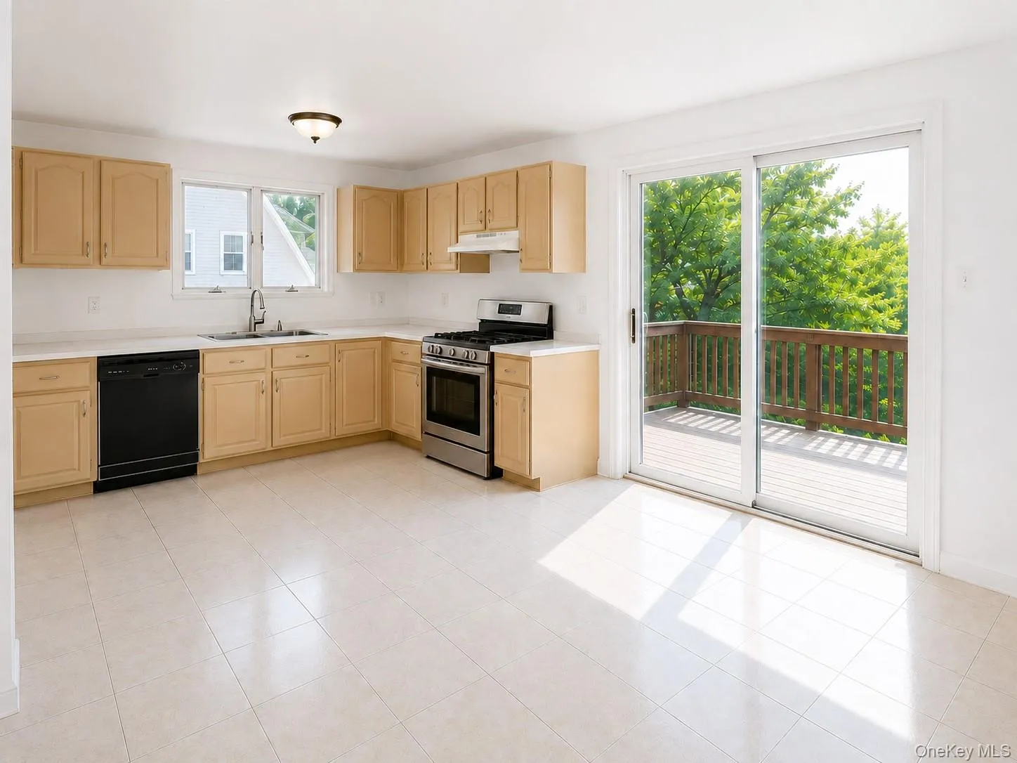 Kitchen featuring light wood cabinetry, white countertops, tile flooring, and a stainless steel oven/range Kitchen featuring light wood cabinetry, white countertops, tile flooring, and a stainless steel oven/range