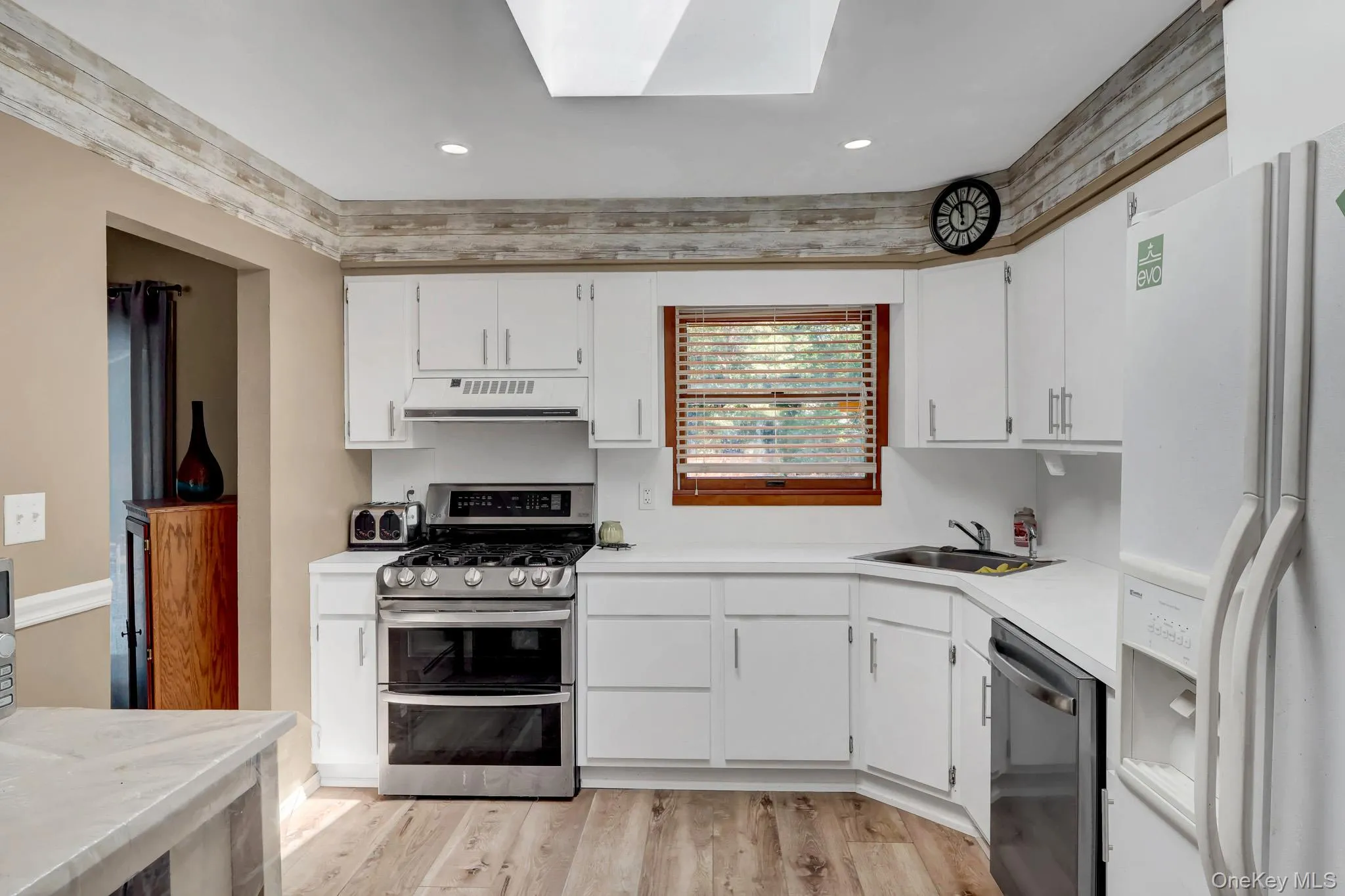 White Kitchen with New Flooring and Newer Stainless Steel Stove and Dishwasher White Kitchen with New Flooring and Newer Stainless Steel Stove and Dishwasher