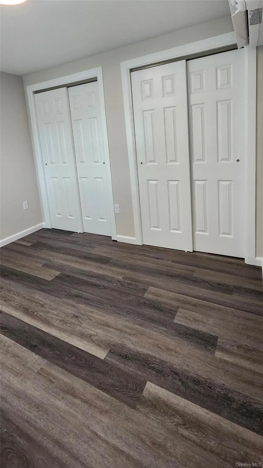 Bedroom with Vinyl Flooring and his and her closets Bedroom with Vinyl Flooring and his and her closets