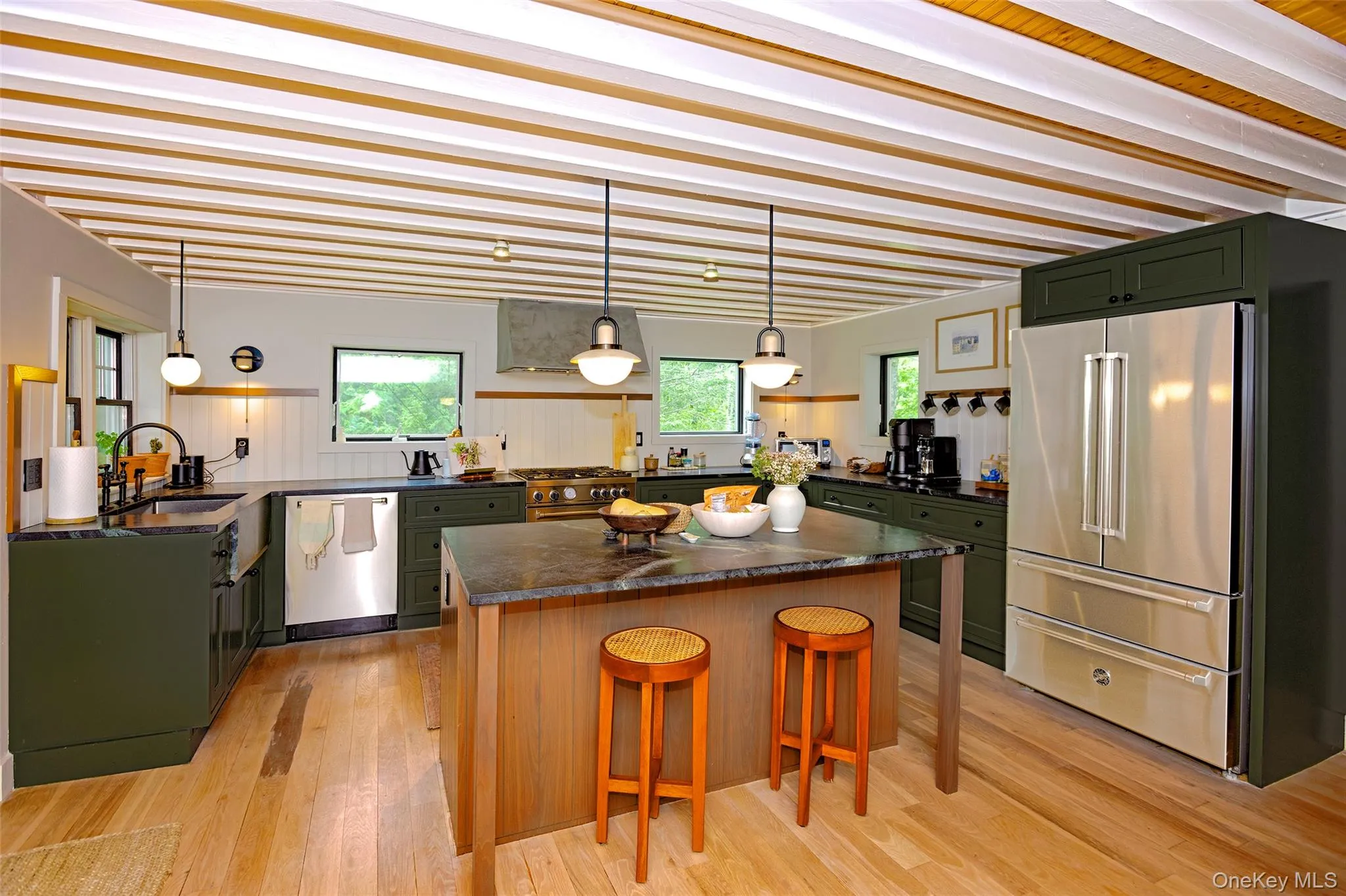 Large island kitchen with professional appliances, abundant granite counter space and a breakfast bar. Large island kitchen with professional appliances, abundant granite counter space and a breakfast bar.