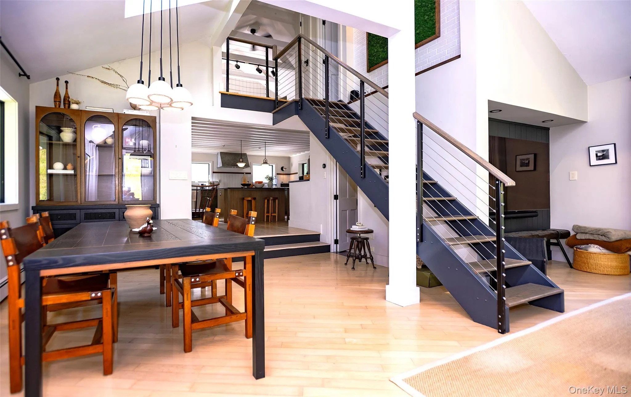 Open architecture with foreground dining room, kitchen and kitchen sitting room beyond and open staircase to second floor bedrooms. Open architecture with foreground dining room, kitchen and kitchen sitting room beyond and open staircase to second floor bedrooms.