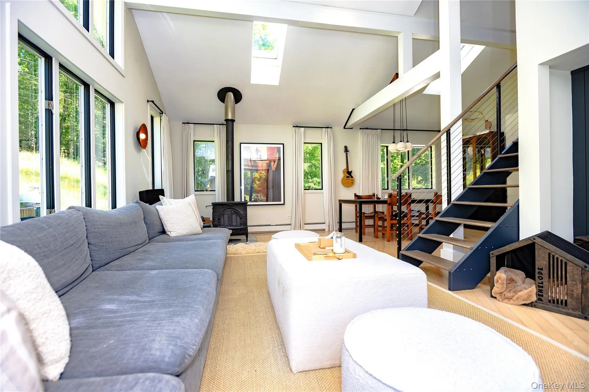 Vaulted ceilings and open architecture of the great room with stairs and dining room area on the far side of the room. Vaulted ceilings and open architecture of the great room with stairs and dining room area on the far side of the room.